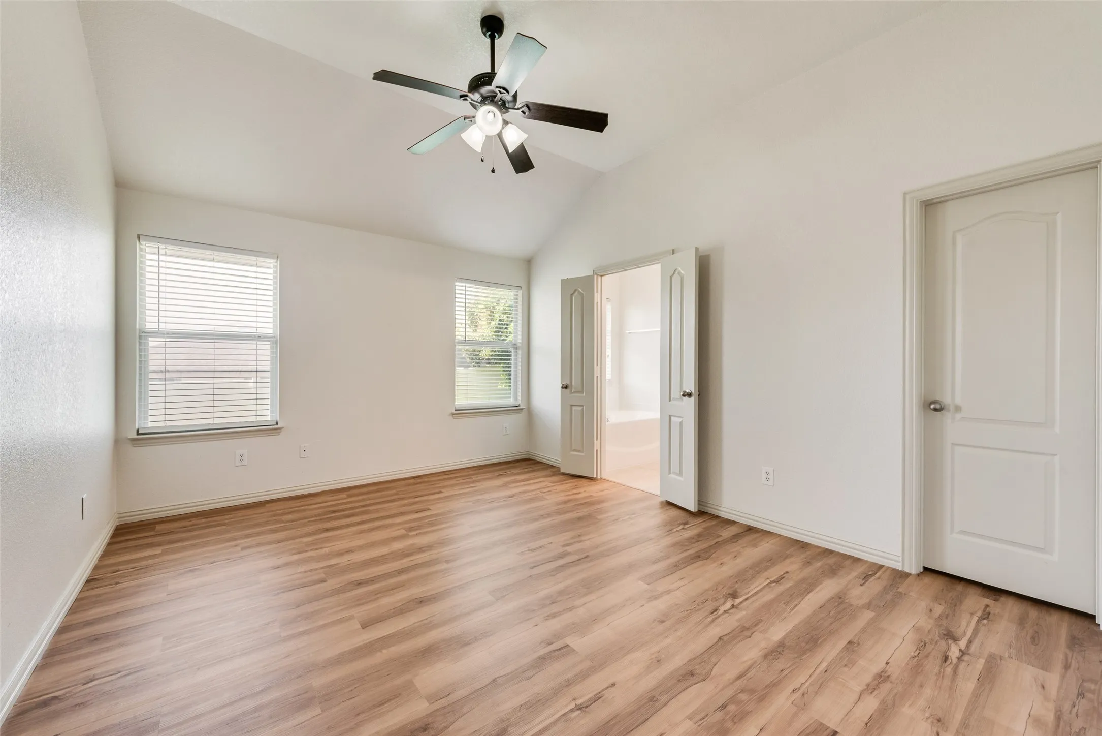 Primary bedroom with ensuite bathroom and walk-in closet