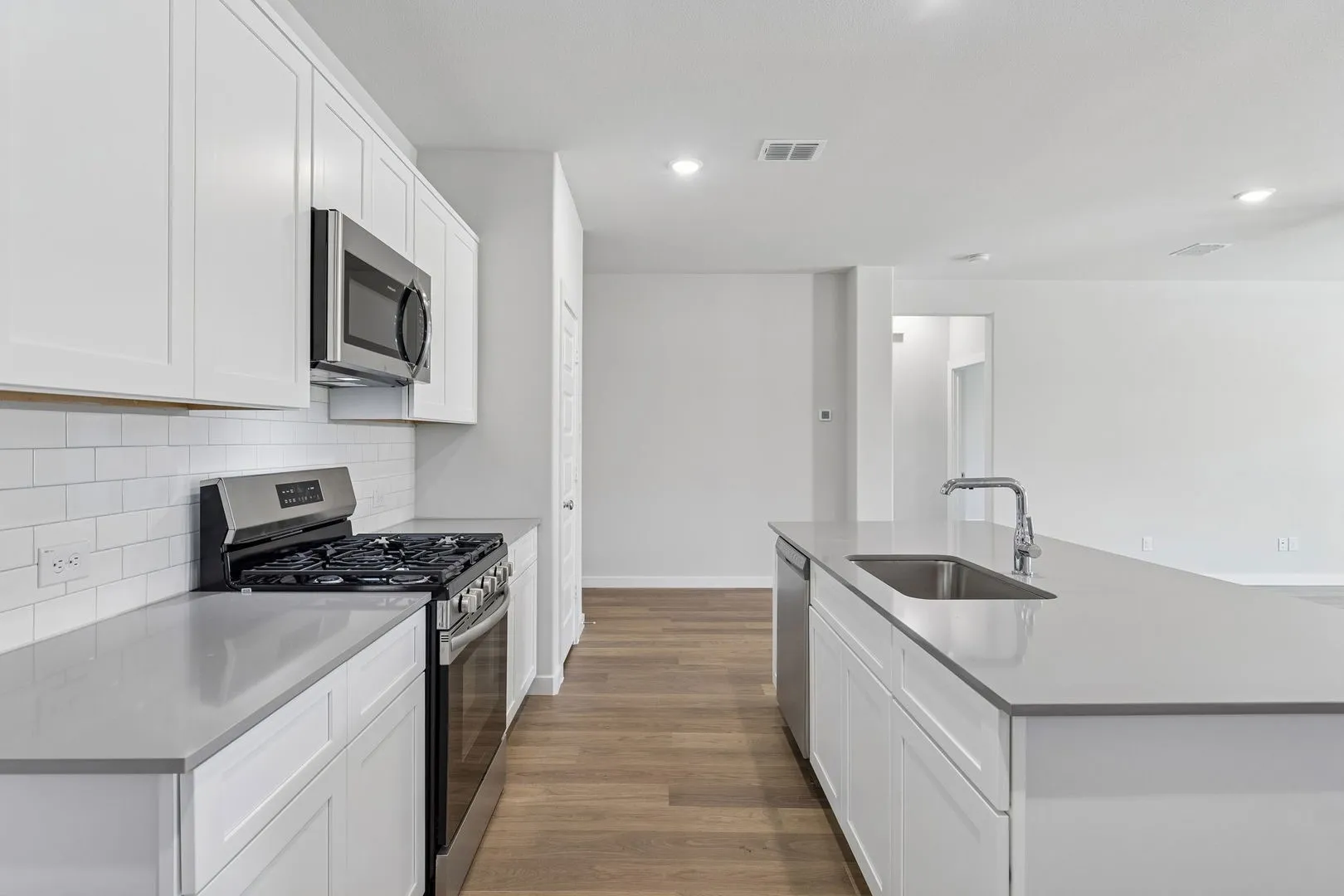 Kitchen in the Harrison home plan by Trophy Signature Homes – REPRESENTATIVE PHOTO