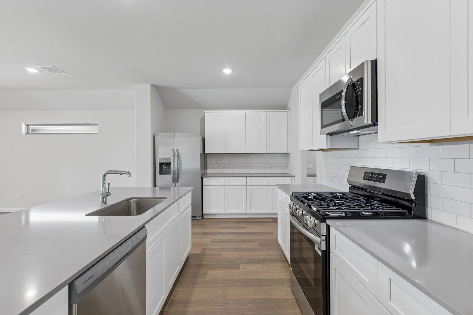 Kitchen in the Harrison home plan by Trophy Signature Homes – REPRESENTATIVE PHOTO