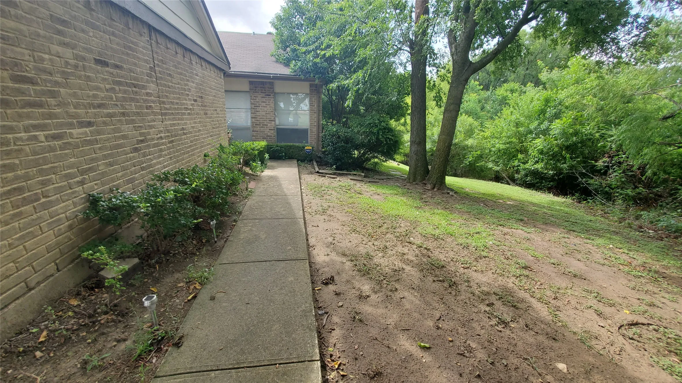 Side yard and walk to the entry door.