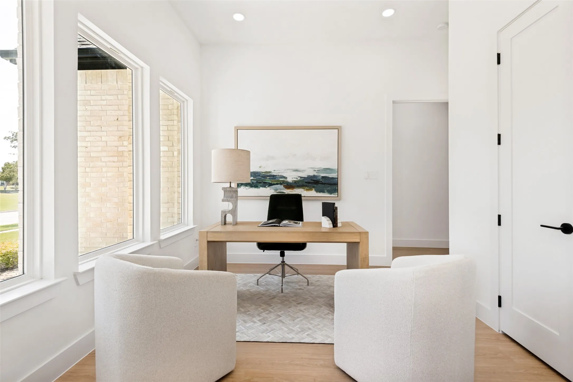 Office space featuring light wood-finish flooring, recessed lighting, and white walls