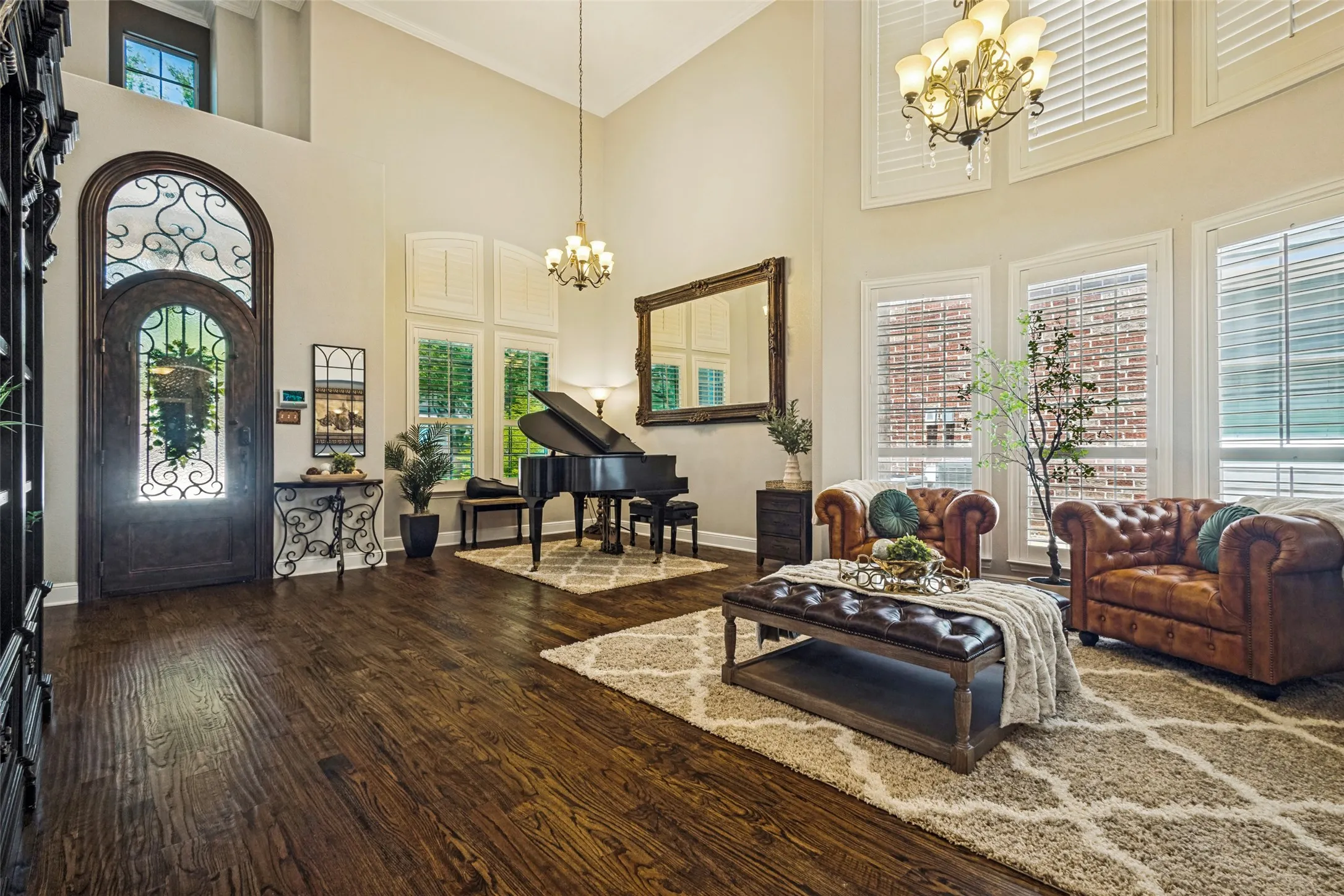 Formal living and dining areas being used as piano room and sitting area. House features imported handmade and unique front door.