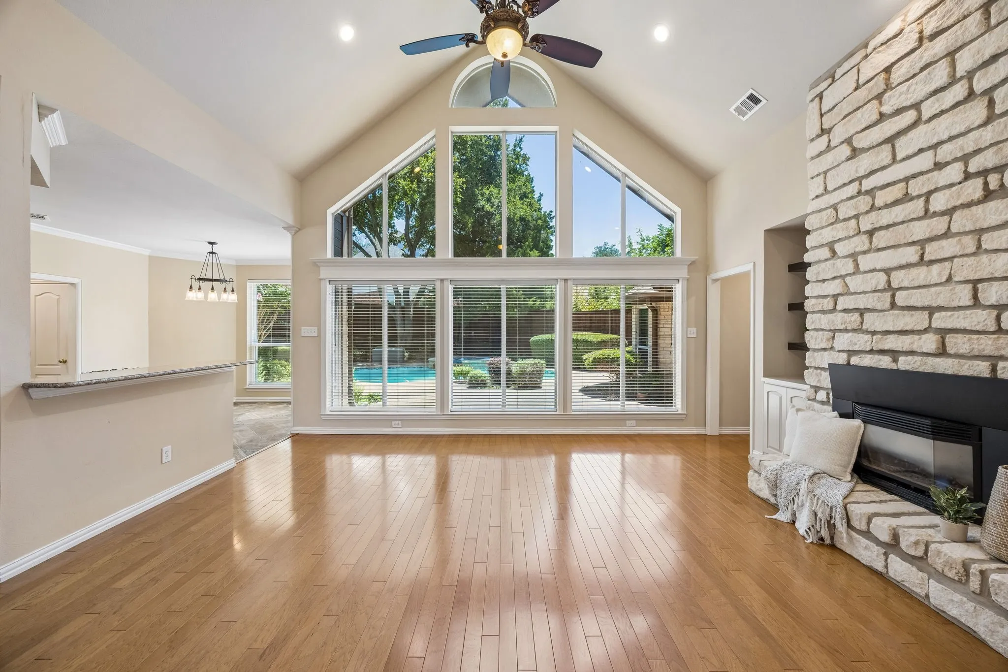 Wow! Look at this view. Gorgeous wall of windows shows the amazing pool and allows abundant sunshine to light the space! The gleam on the wood flooring is beautiful.
