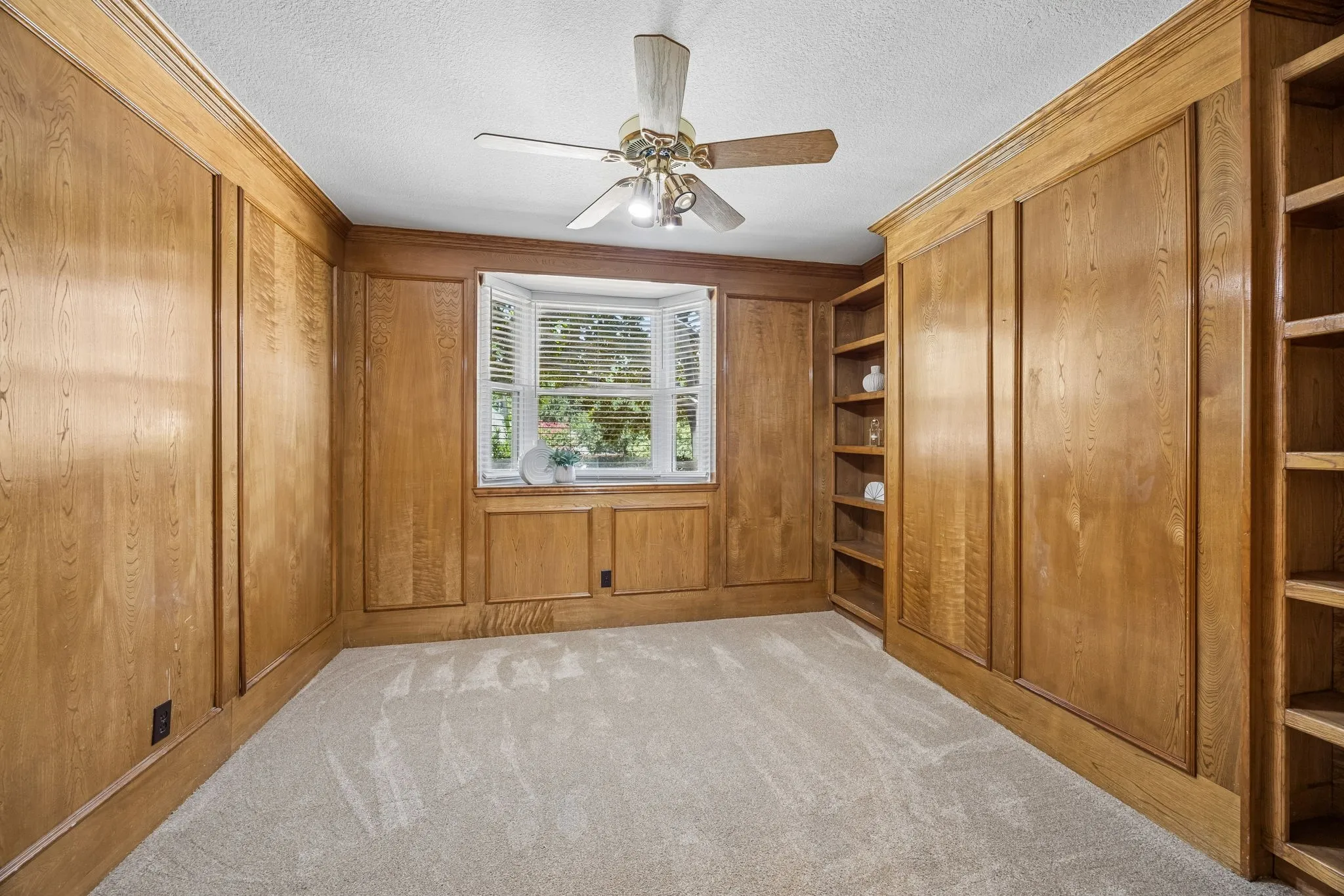 This space is currently configured as an office but would make a perfect 4th bedroom. The space does offer a closet and has a bath adjacent. With a little imagination, this could be a guest room or even a nursery that is steps away from the primary. Built in shelves and a window ledge offer places for books, art or even toys.