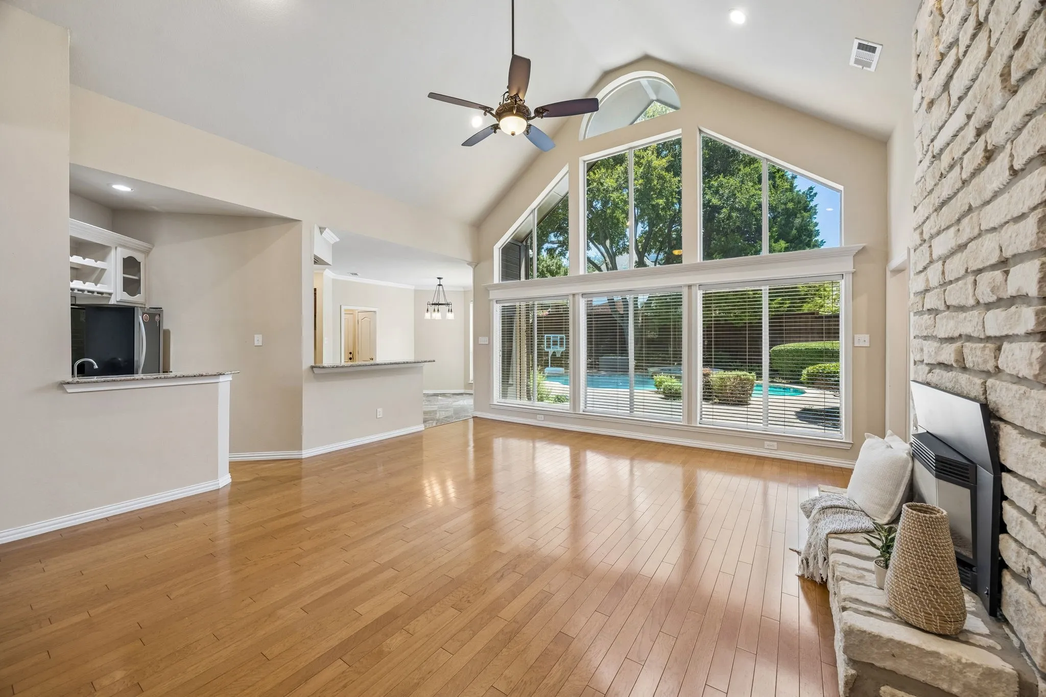 The angle shows the flow to the kitchen and casual dining space as well as the wet bar area.