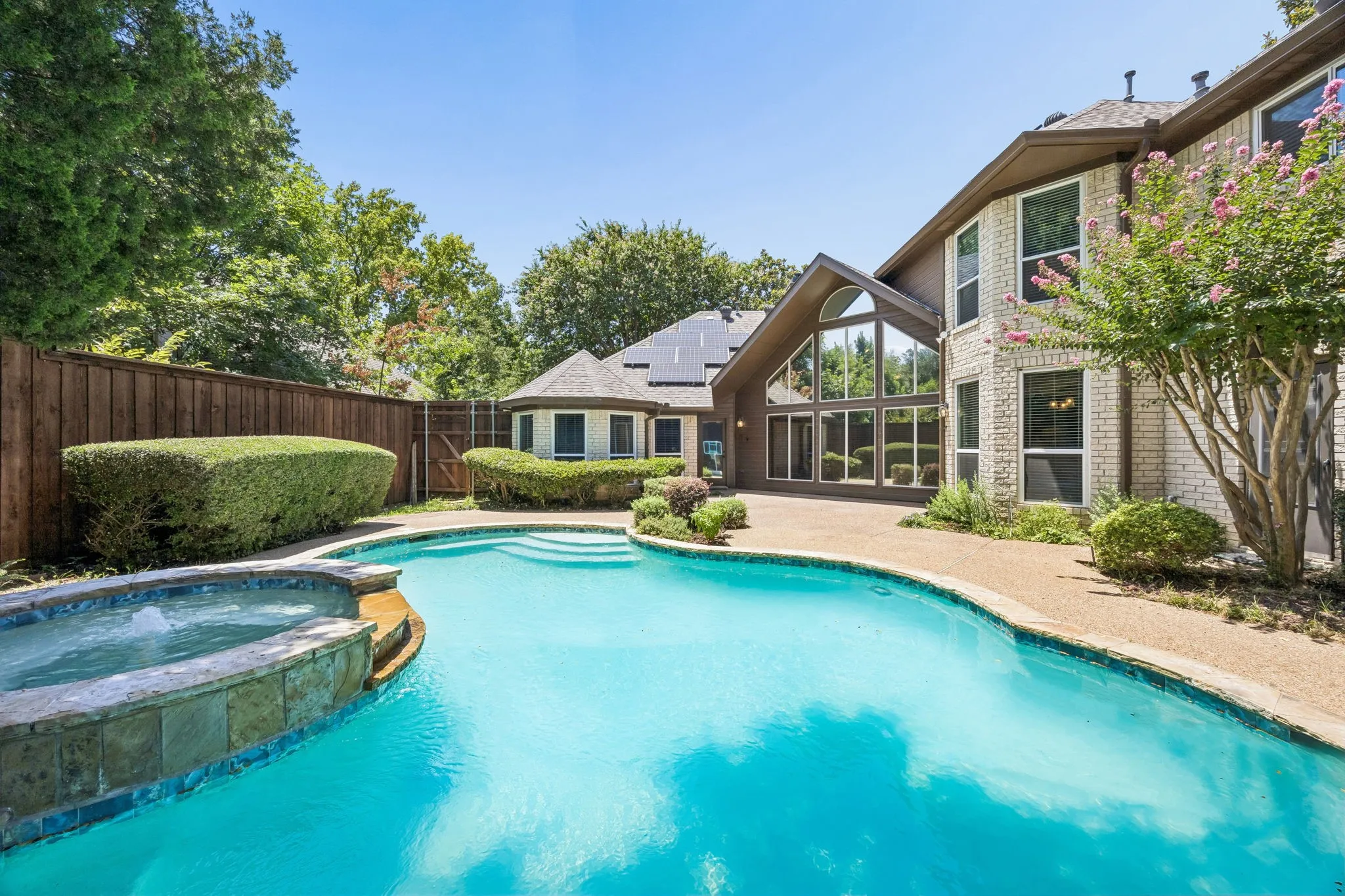 Cool down on hot summer days in this refreshing pool. Enjoy the privacy of high fencing as well as much of the house due to the unique layout and placement on the lot. The gate shown in the background leads to a small garden plot.