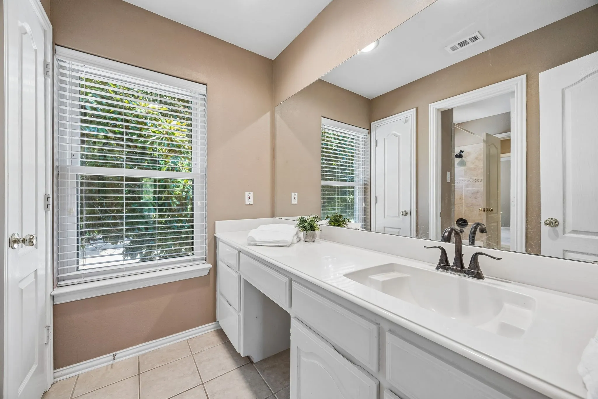The second vanity area offers linen closet, storage and place to sit while getting ready for your day.