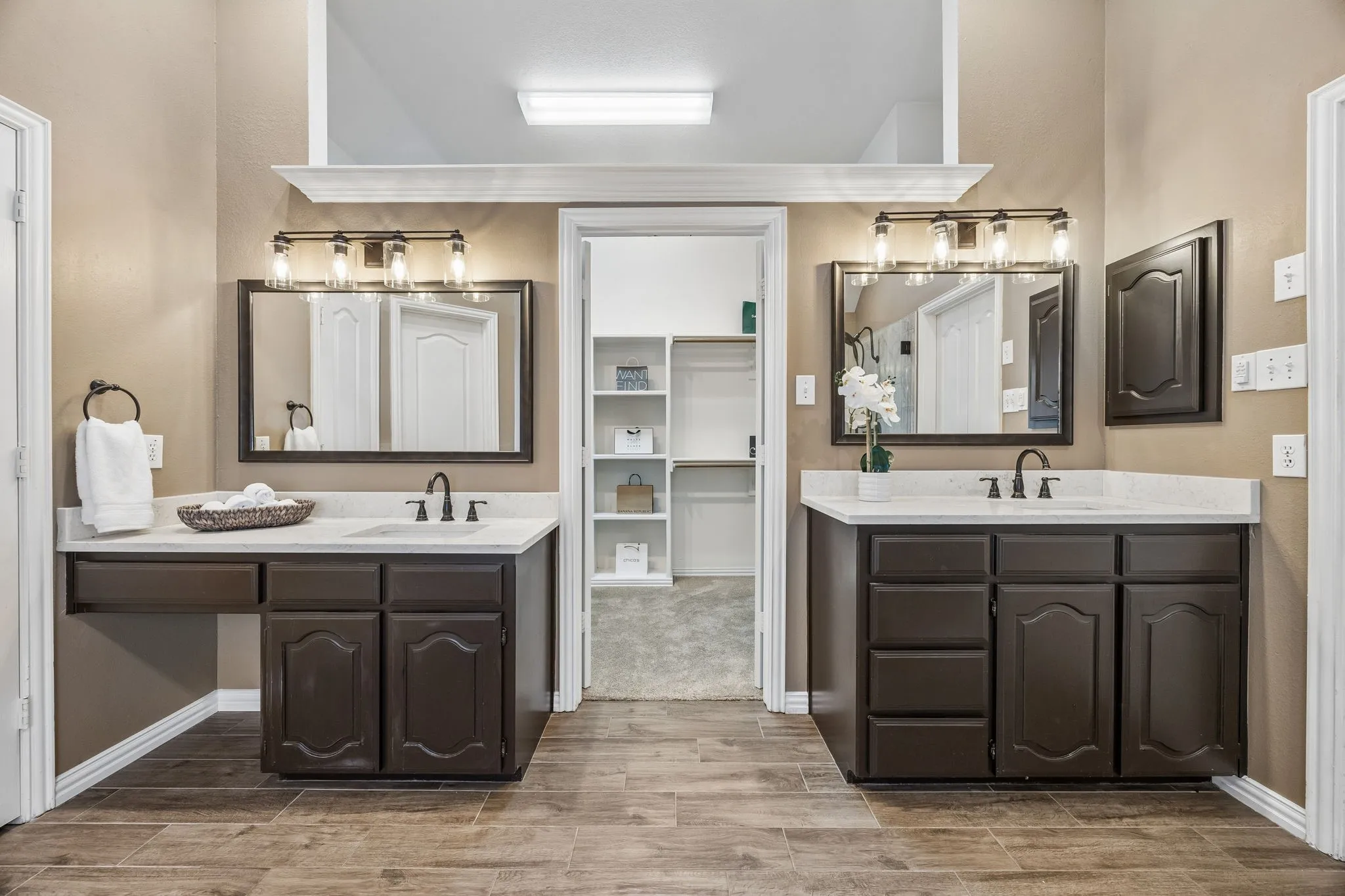 The spa-like primary bath offers a oversized separate frameless shower with bench, large jetted tub, double vanities and a CEILING FAN.