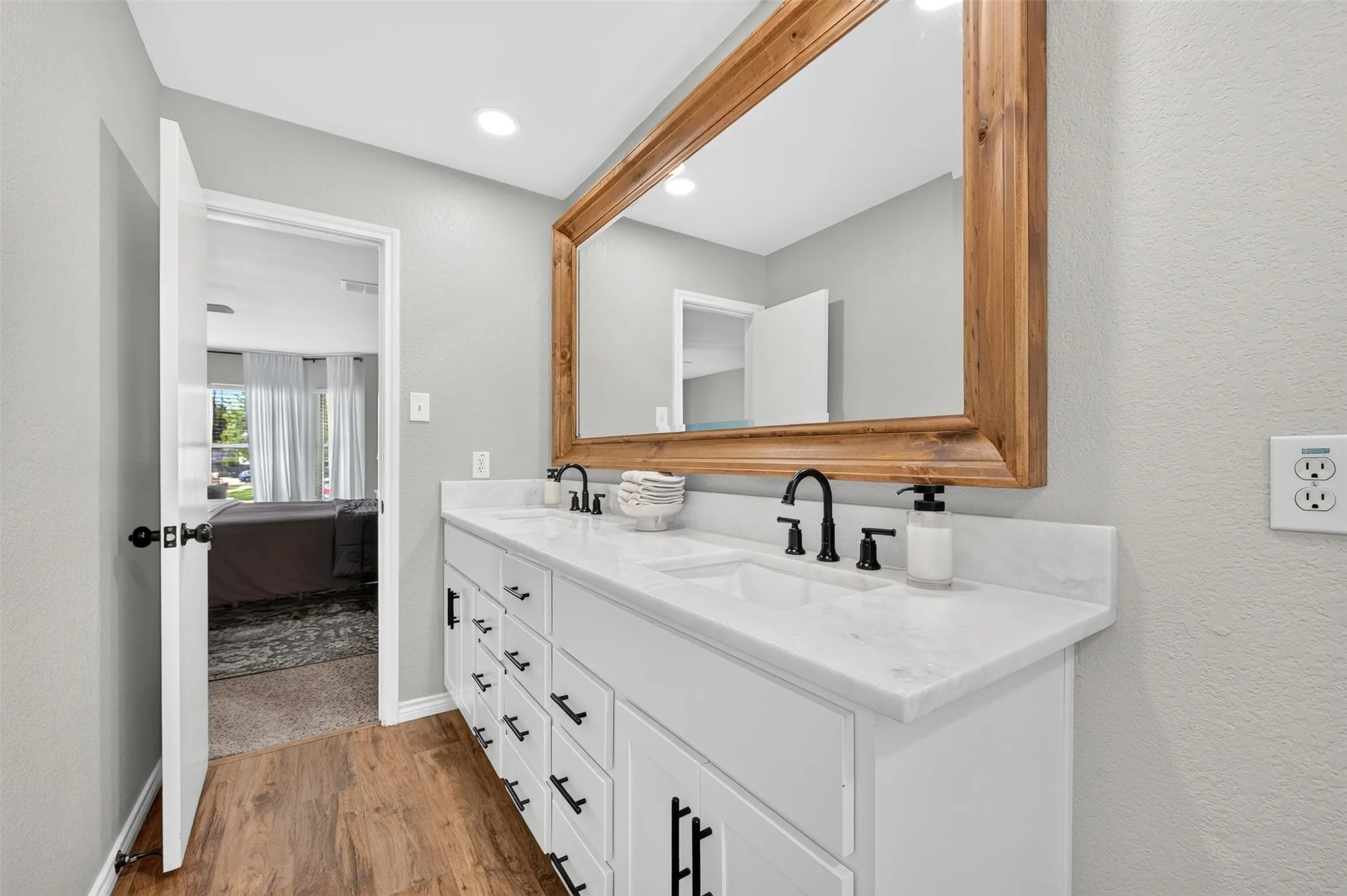 Dual vanity with white cabinetry and black hardware