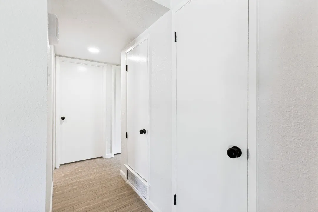 A COAT CLOSET AND LINEN CLOSET OR ROOM FOR KIDS SPORTS EQUIPMENT - SOCCER, BASEBALL, FOOTBALL