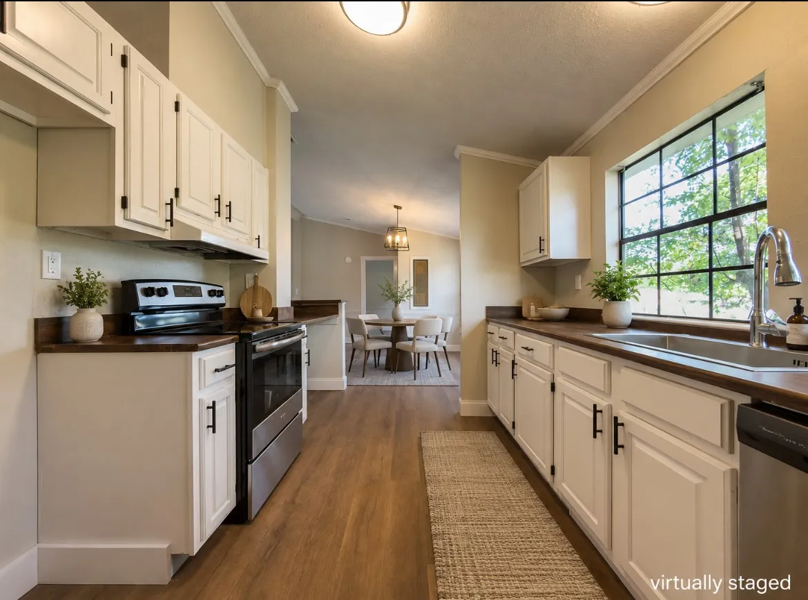 Kitchen featuring white cabinetry with dark hardware, dark wood-finish countertops, stainless steel appliances, and wood-finish flooring
