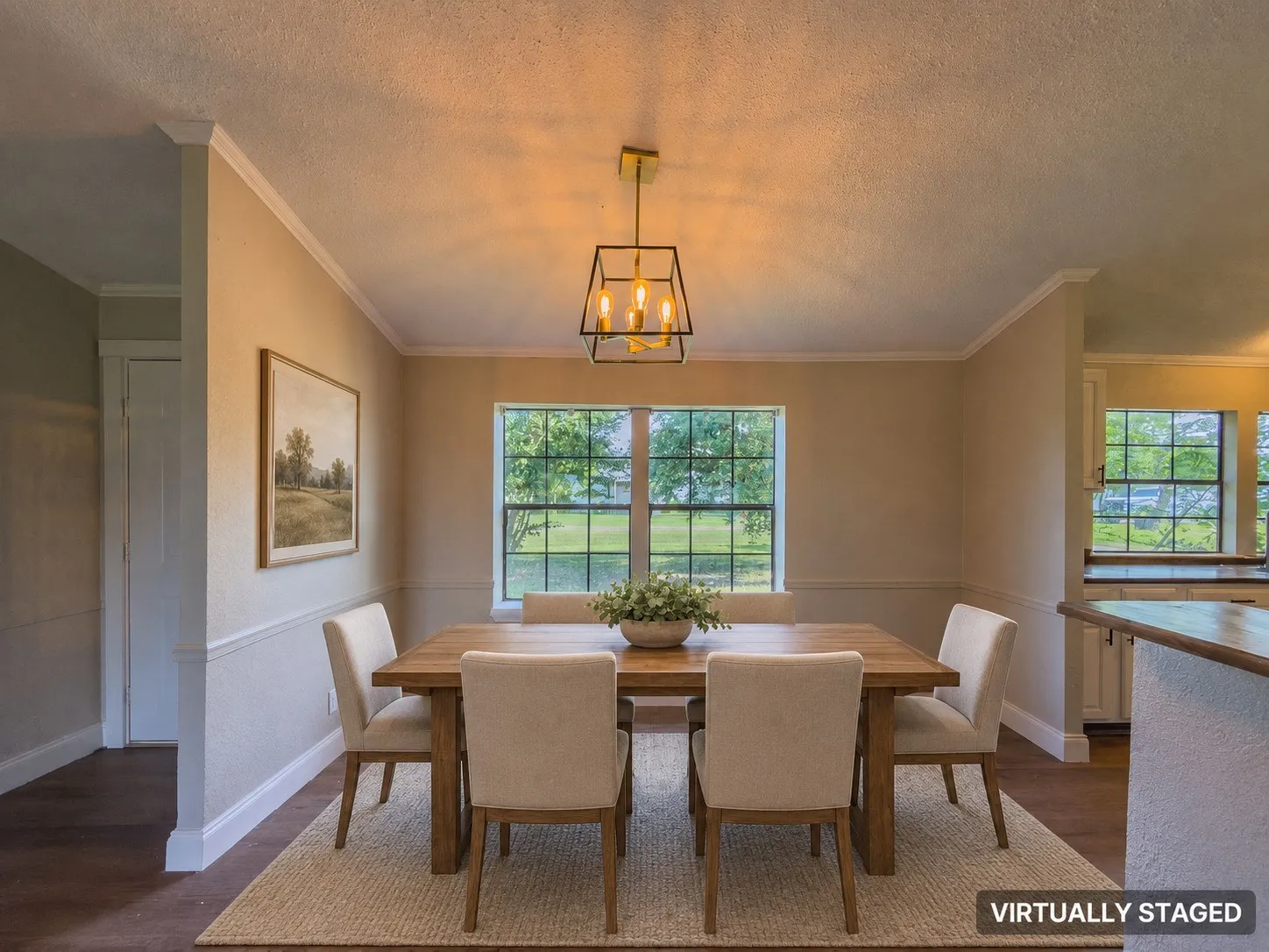 Dining area featuring a contemporary geometric chandelier, wainscoting, crown molding, and wood-finish flooring