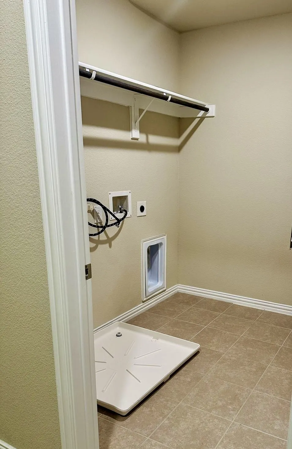 Clothes washing area with tile floors, washer hookup, and electric dryer hookup