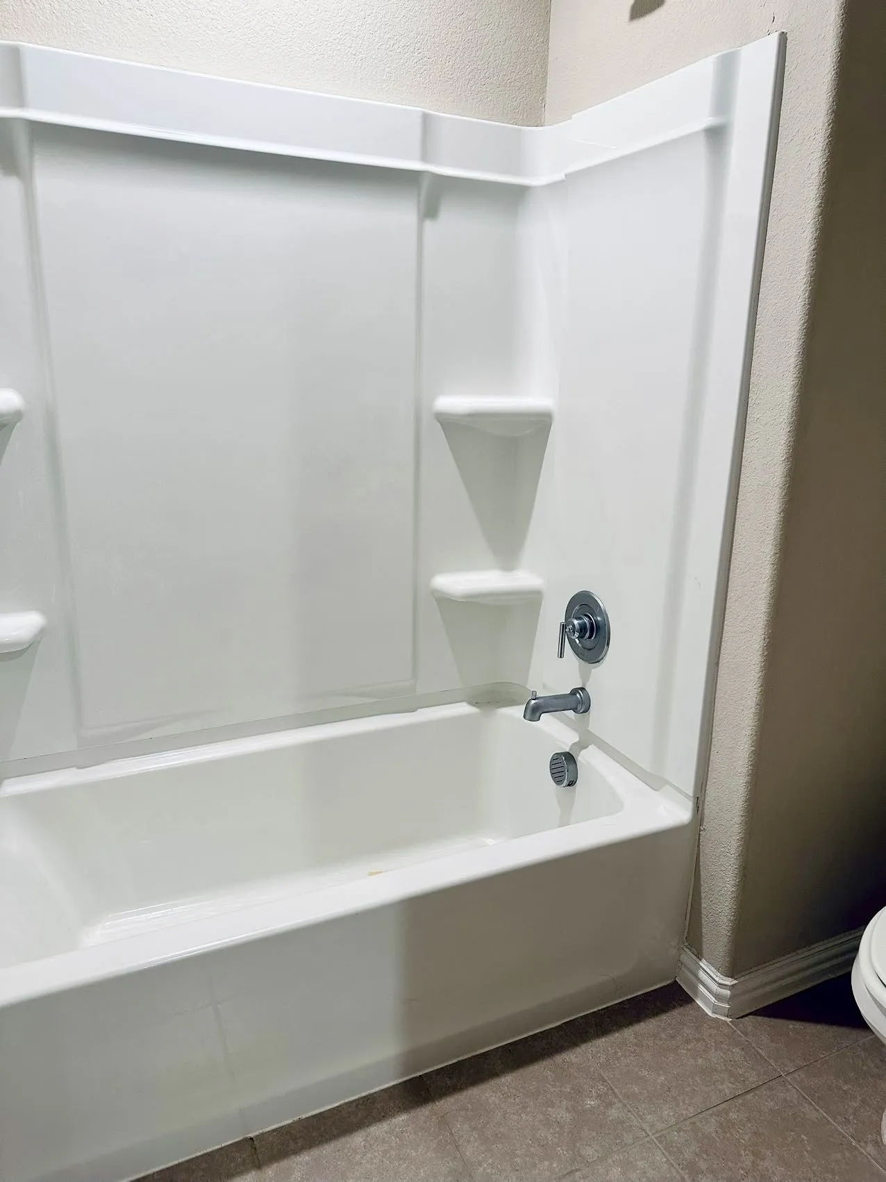 Bathroom with  shower combination, toilet, and tile floors