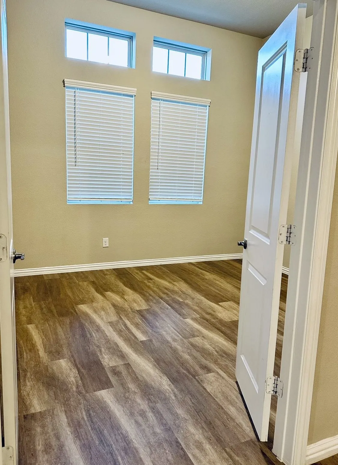 Spare room featuring plenty of natural light and hardwood / wood-style floors