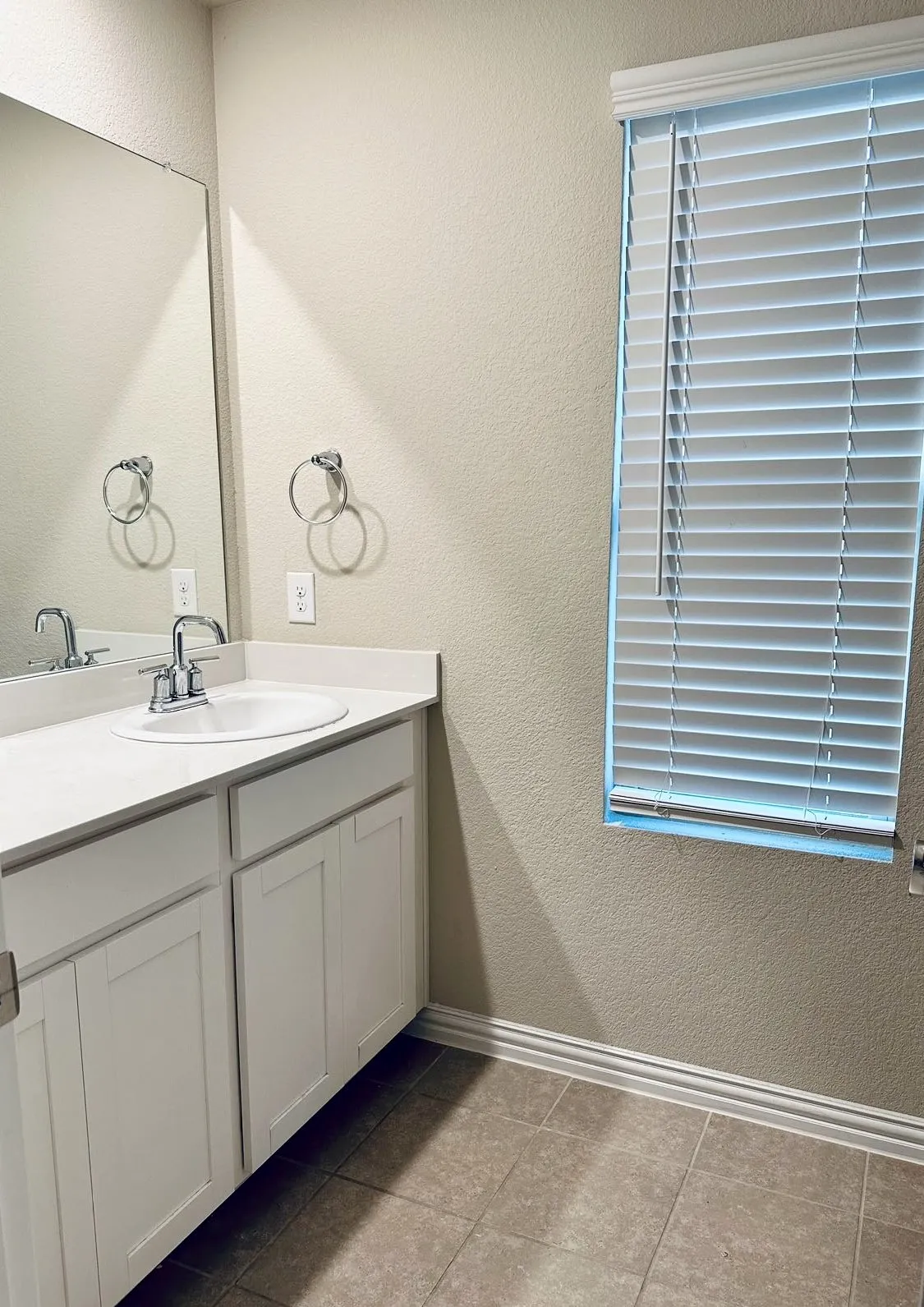 Bathroom featuring tile flooring and vanity