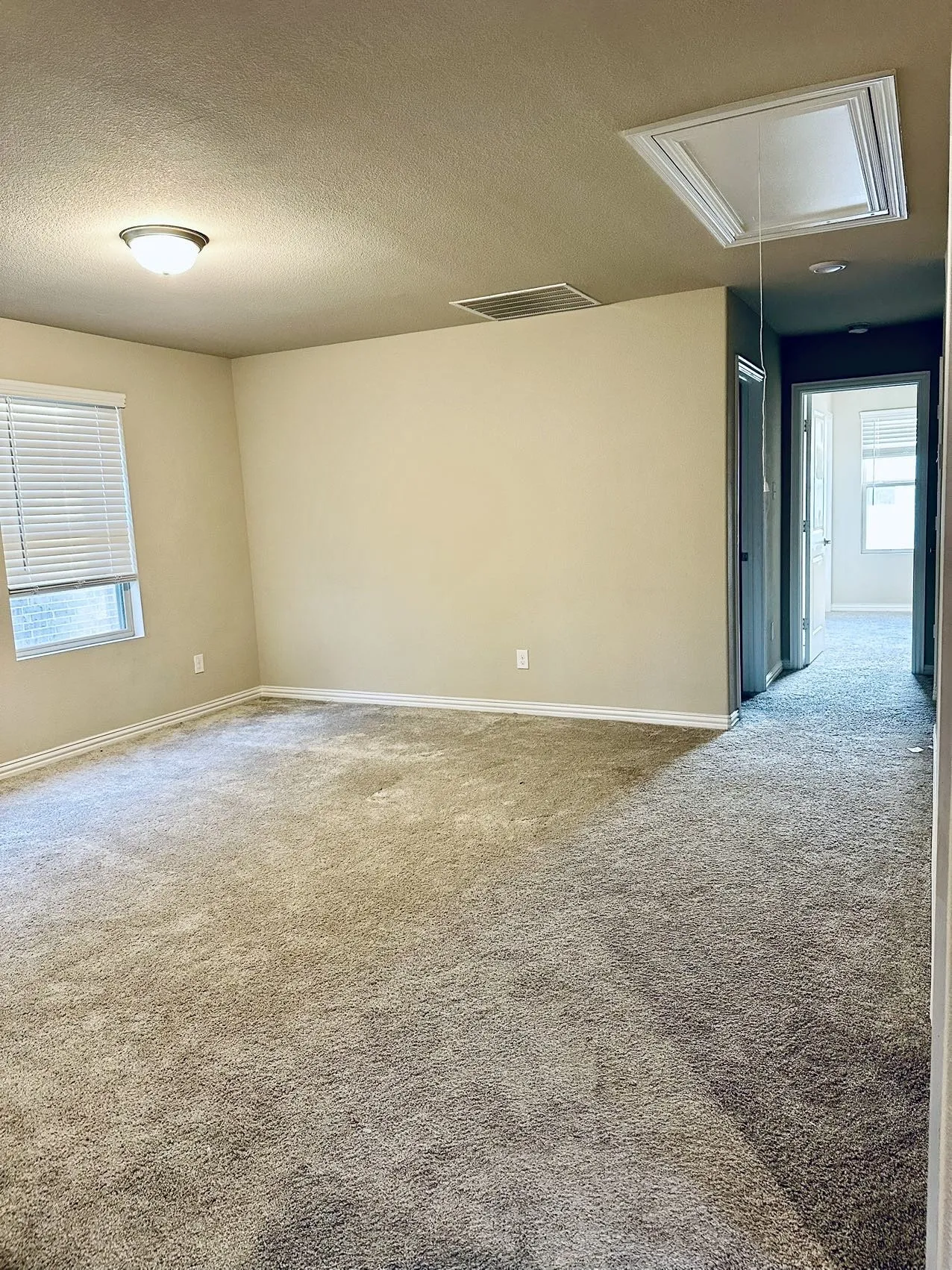 Carpeted spare room with a textured ceiling