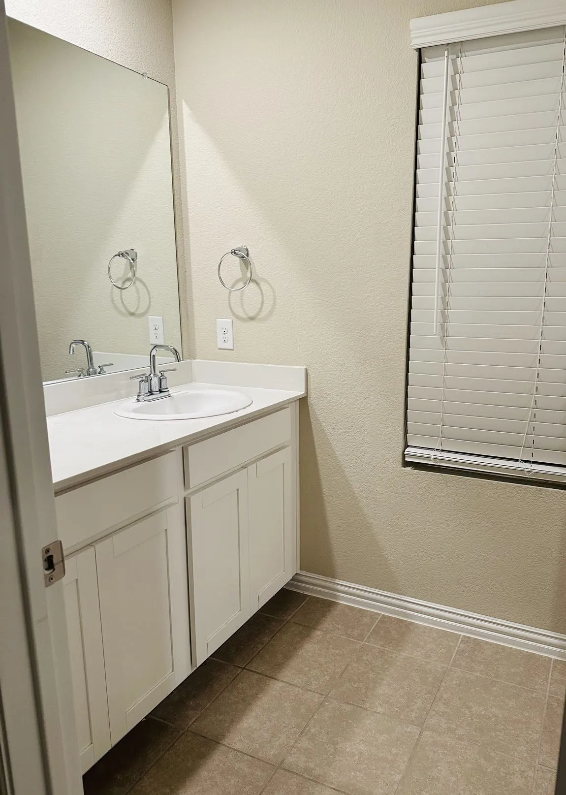 Bathroom featuring tile floors and vanity with extensive cabinet space