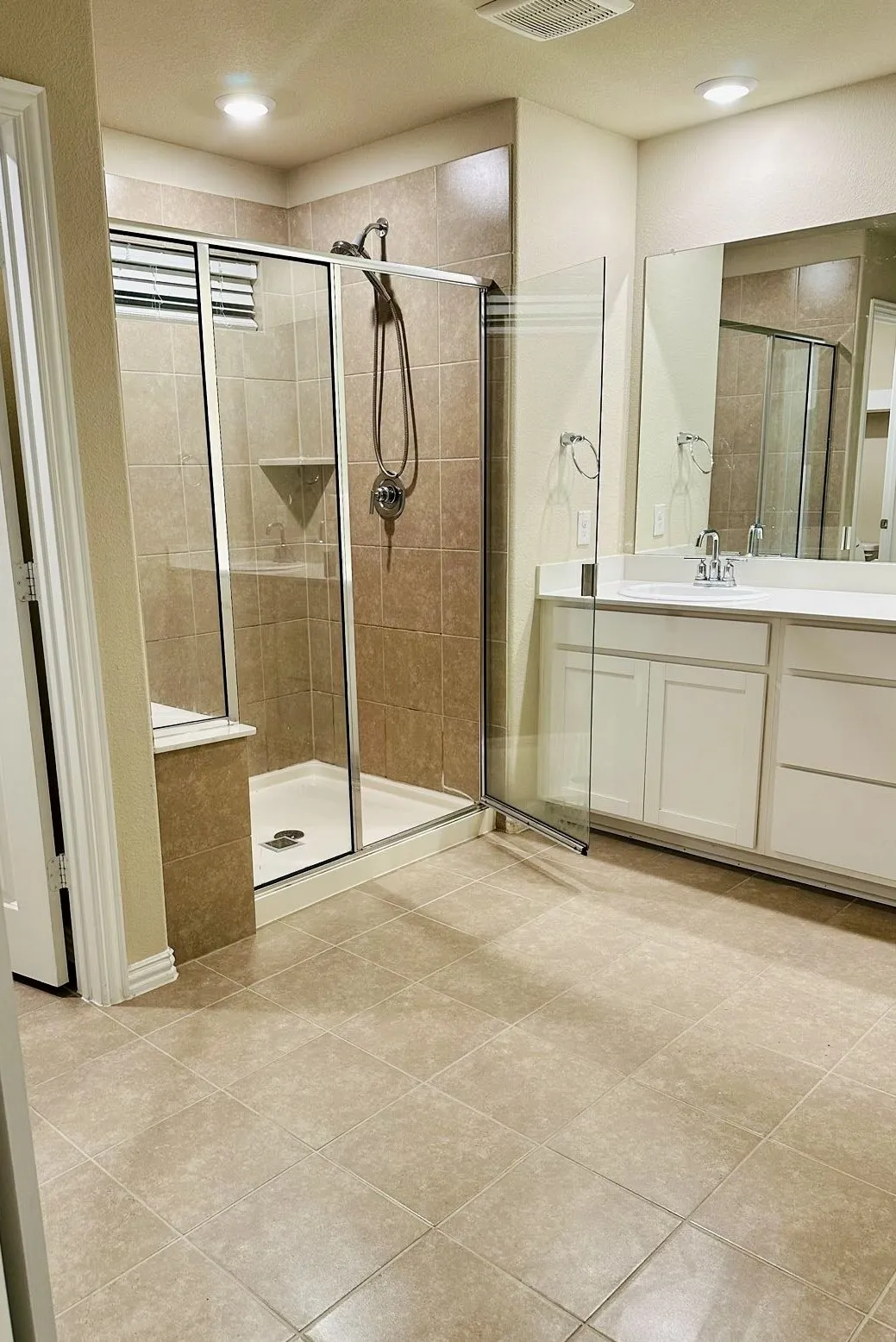 Bathroom featuring tile floors, walk in shower, a textured ceiling, and vanity