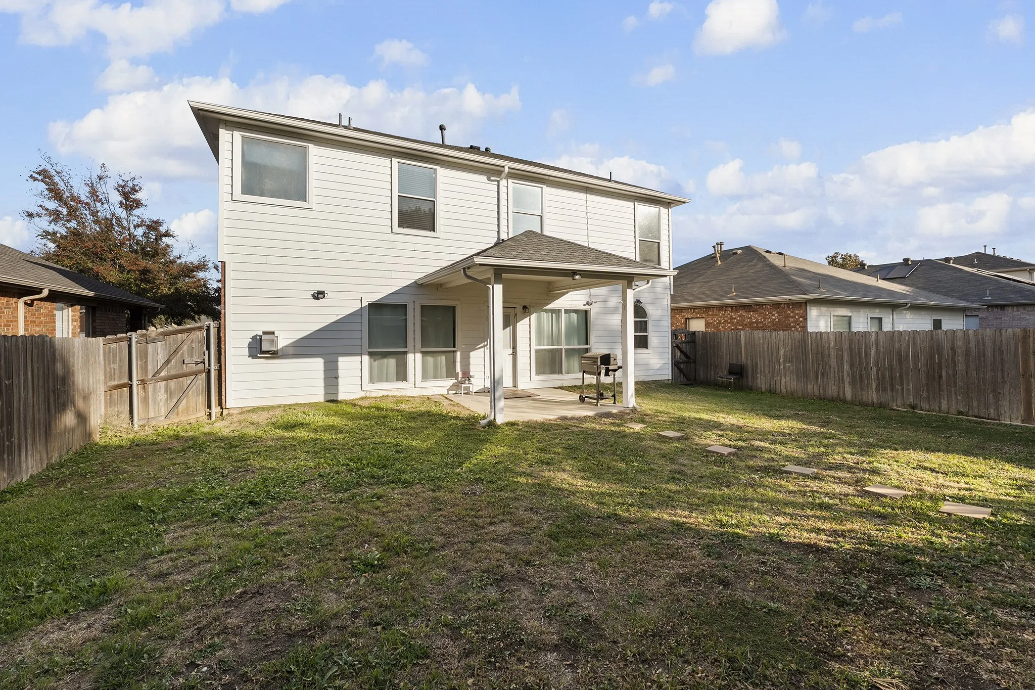 Back of property with a patio and a fenced backyard