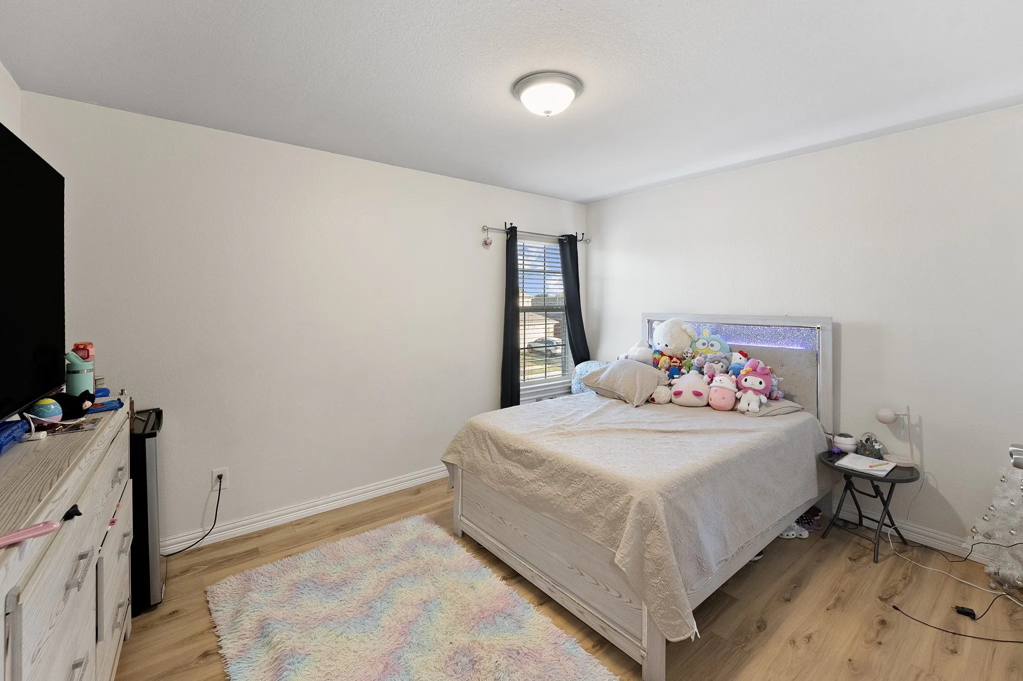 Bedroom with light wood-style floors and baseboards