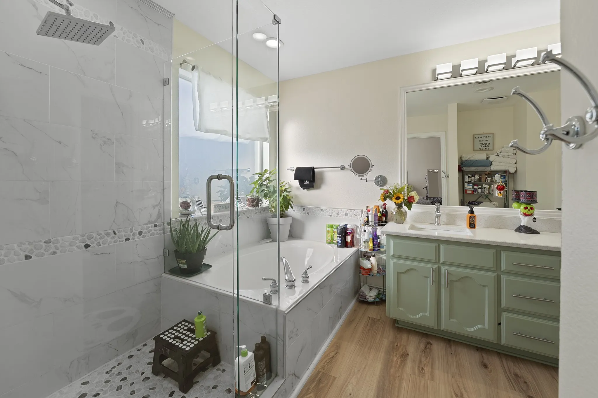 Full bathroom with vanity, a marble finish shower, light wood-type flooring, and a bath