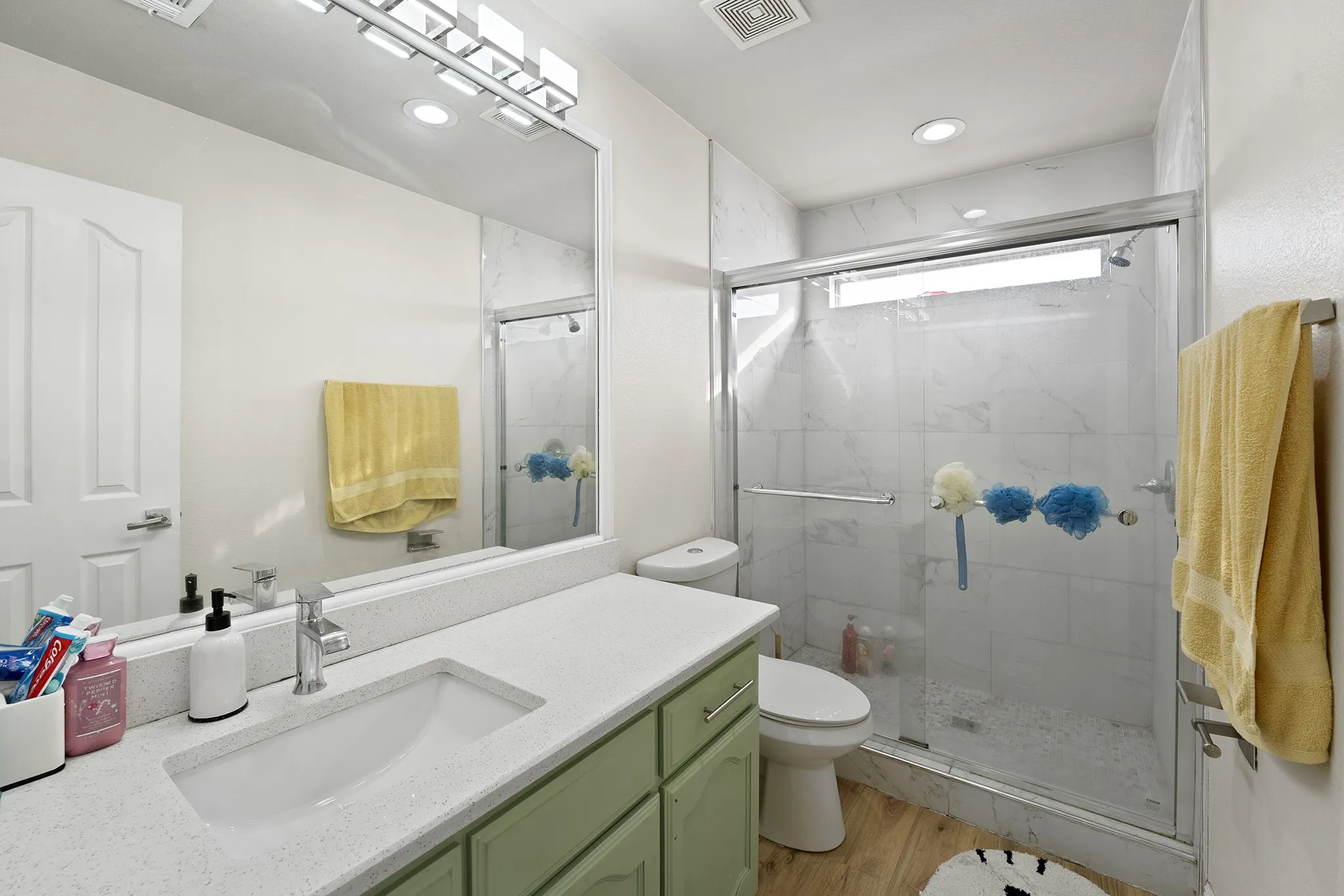 Bathroom with vanity, a shower stall, light wood-style floors, and recessed lighting