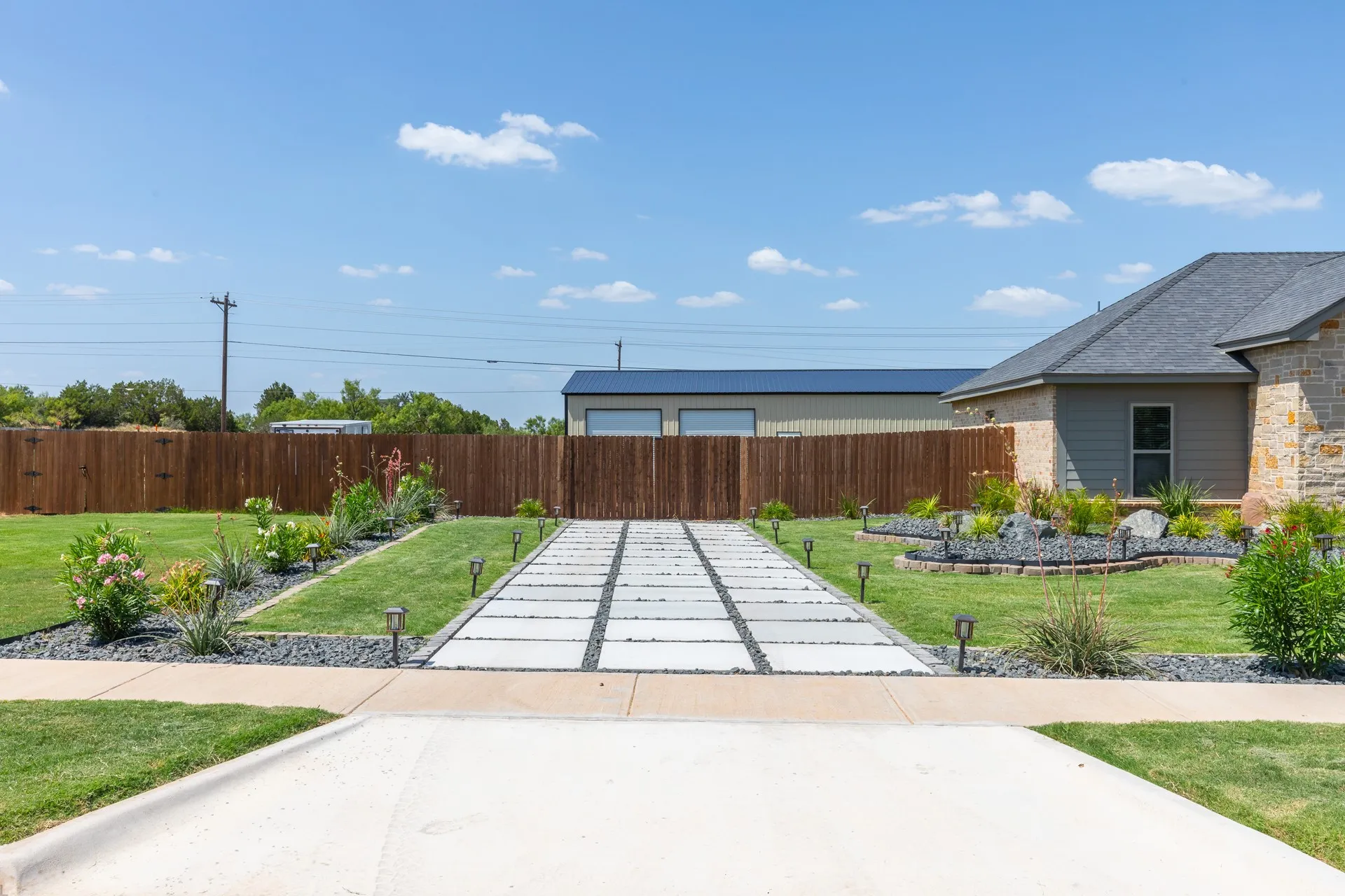 Concrete paver driveway with integrated pathway lighting