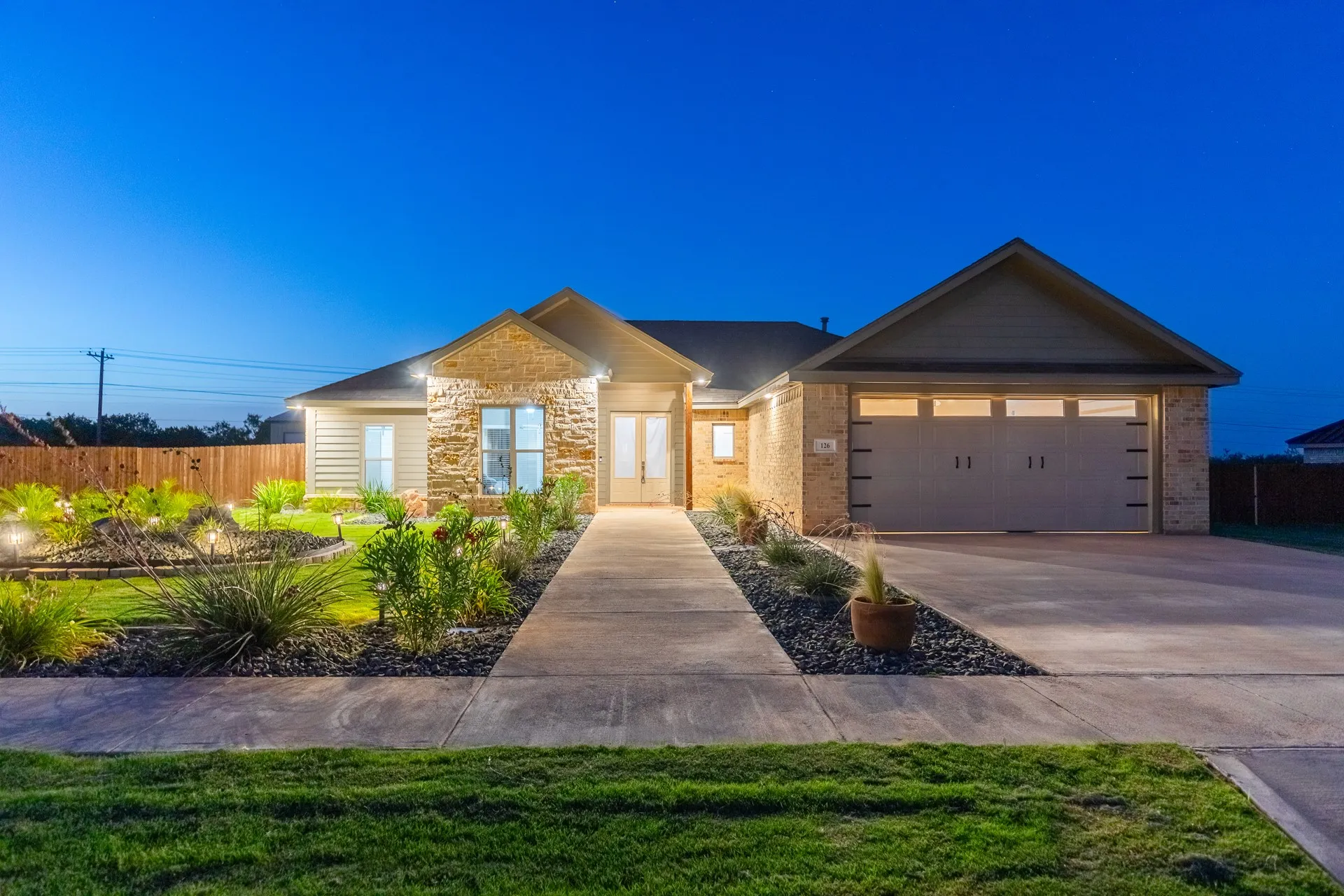 Contemporary single-story residence featuring a stone and siding exterior