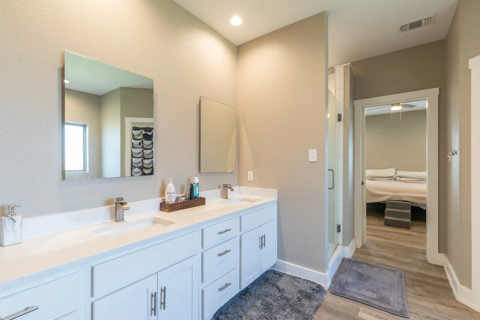 Dual vanity with white cabinetry and integrated sinks