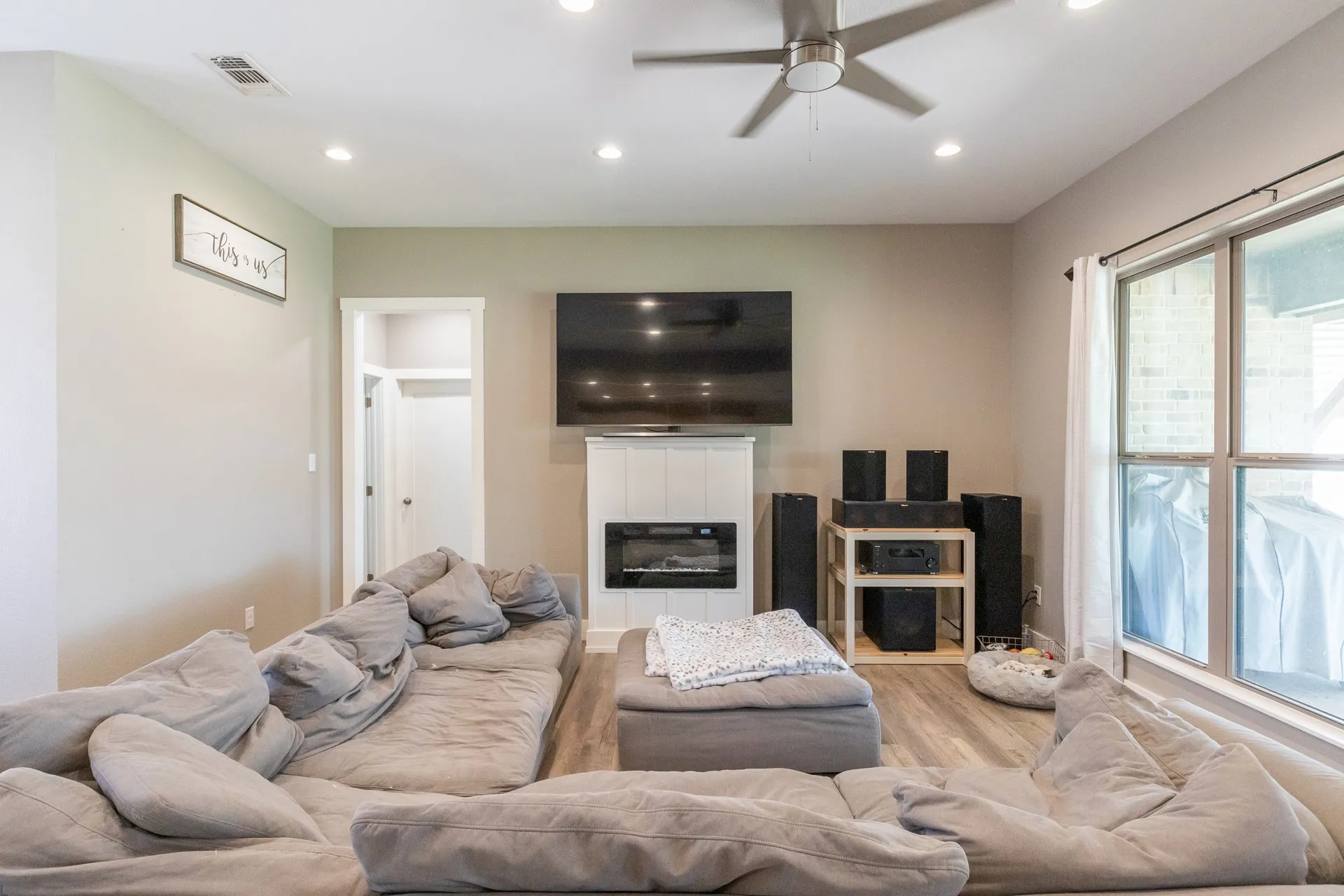 Living area featuring wood-finish flooring, recessed lighting, and a modern ceiling fan