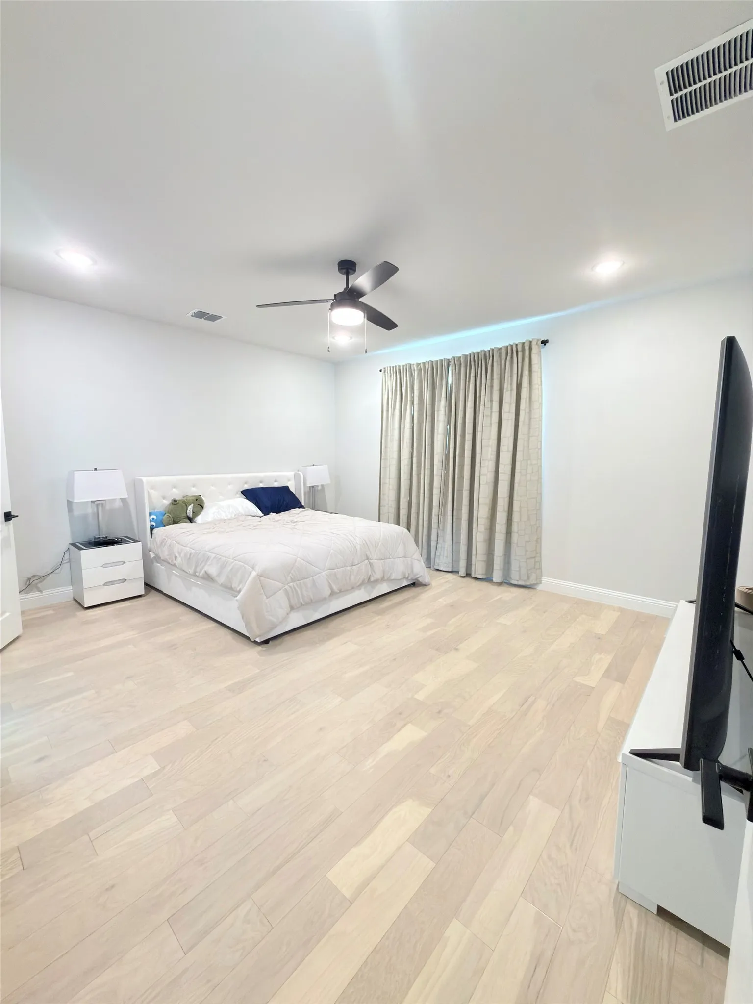 Spacious room with light wood-finish flooring