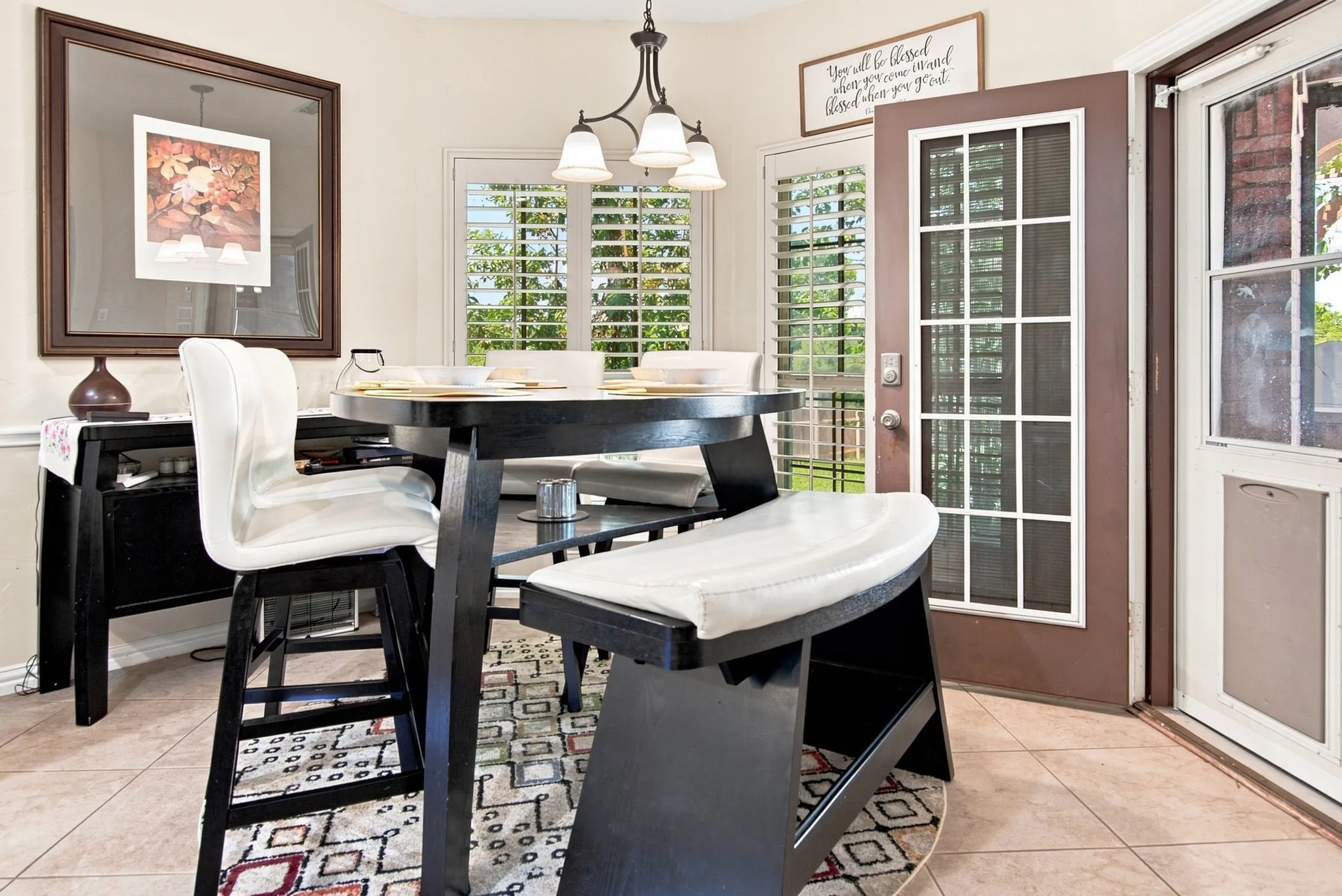 Tiled flooring complements a dining area featuring a dark wood-finish table and bench seating