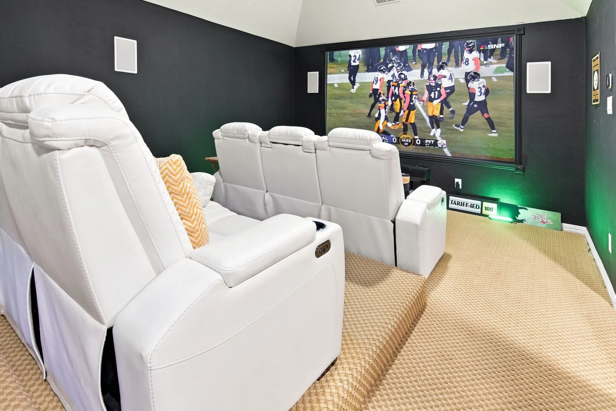 Dedicated media room featuring a large projector screen