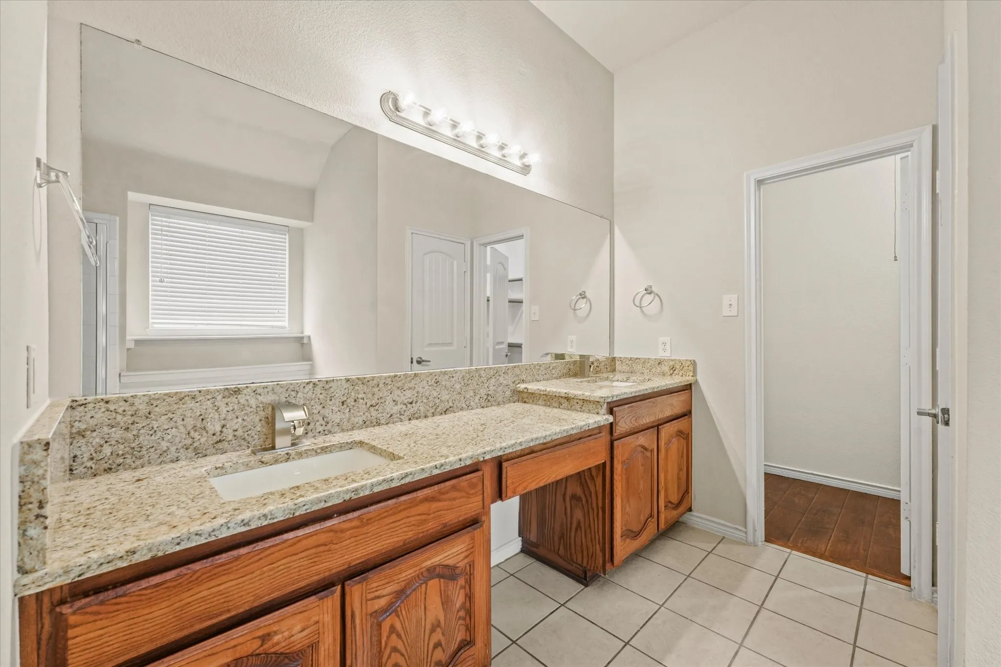 Bathroom featuring tile floors and double sink vanity