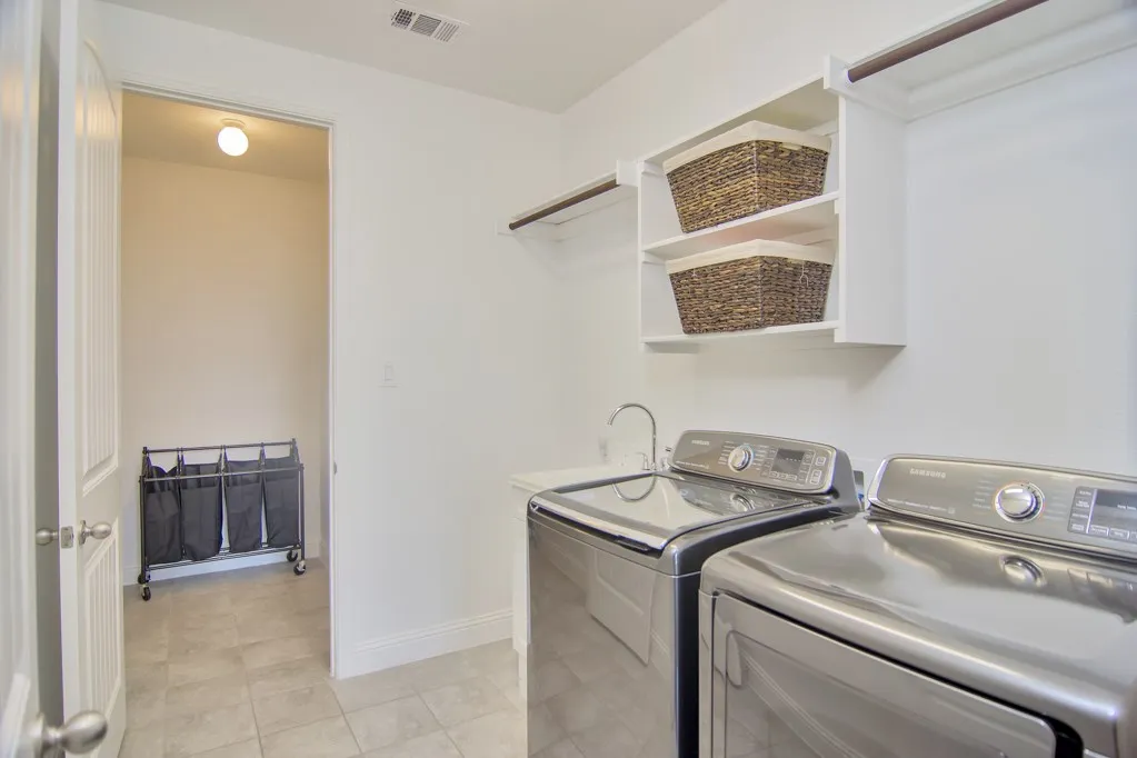 Plenty of space for laundry, check out the sink, and the extra room for your sweet pet to have his/her own space or make it a mud room for the kids' backpacks and shoes!