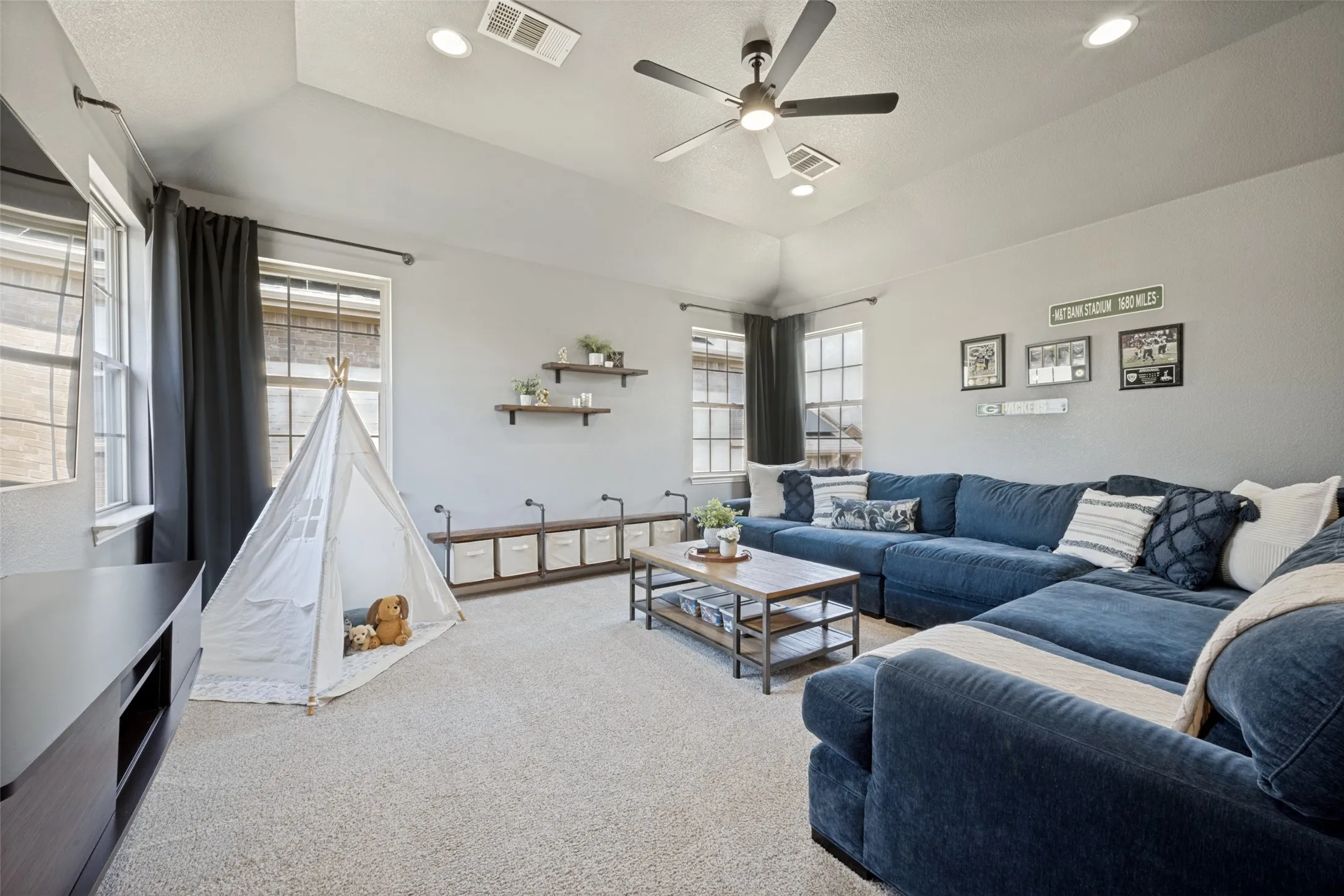 The spacious upstairs game room offers a versatile retreat perfect for movie nights, game days, or a playroom. Filled with natural light from multiple windows, this inviting space provides plenty of room for a larger sectional, media setup, and flexible seating. Whether entertaining guests or creating a cozy family hangout, this bonus living area adapts to your lifestyle.