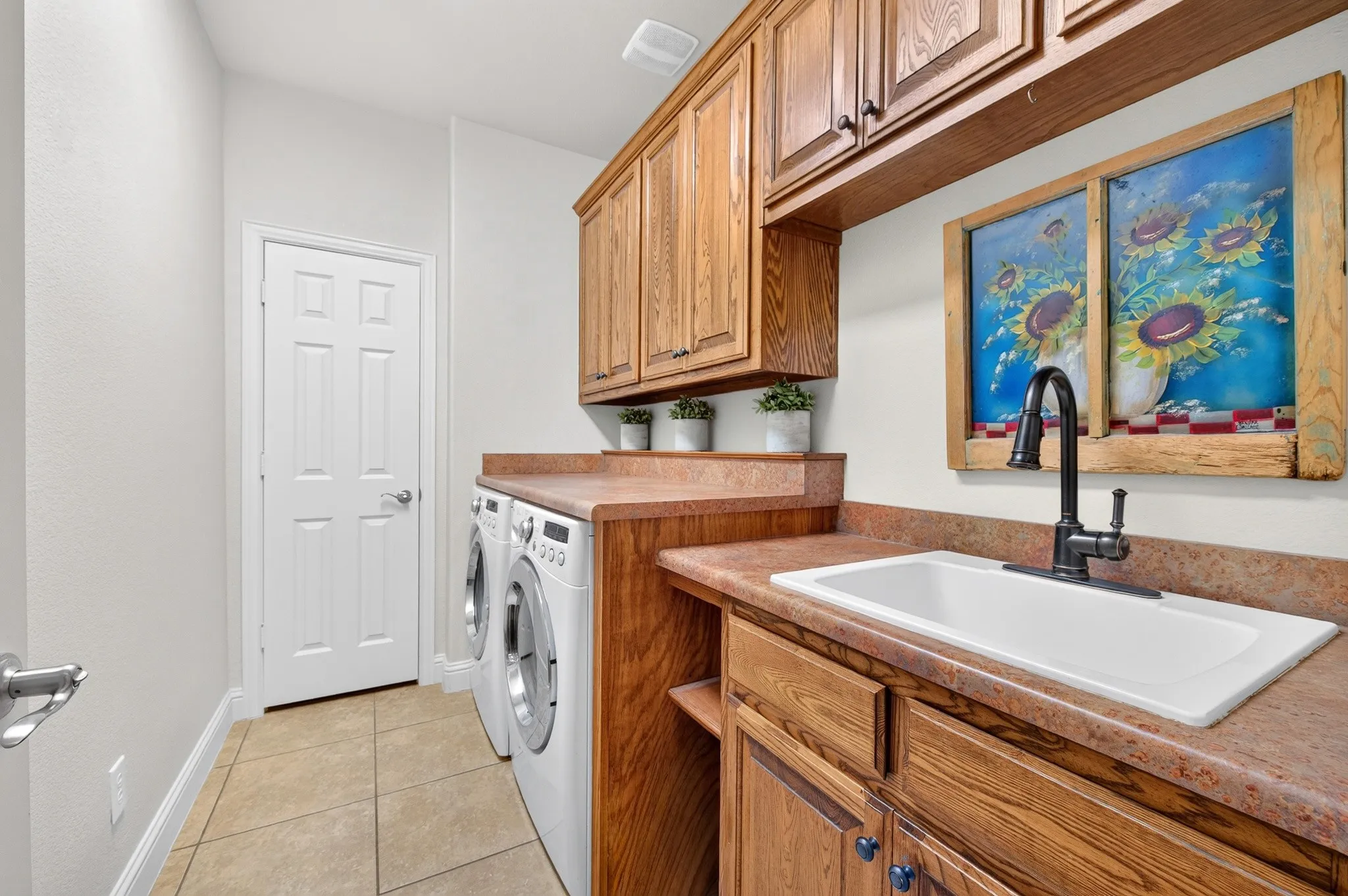 Large utility room complete with built in washer and dryer that convey!