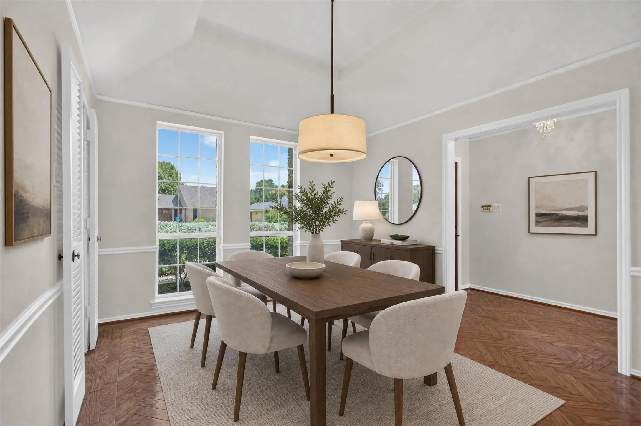 Dining area featuring a vaulted ceiling and two large windows
