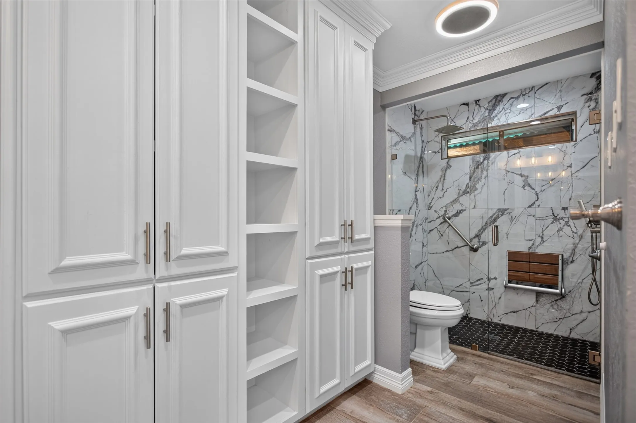 White shaker-style cabinetry with brushed nickel hardware and integrated shelving