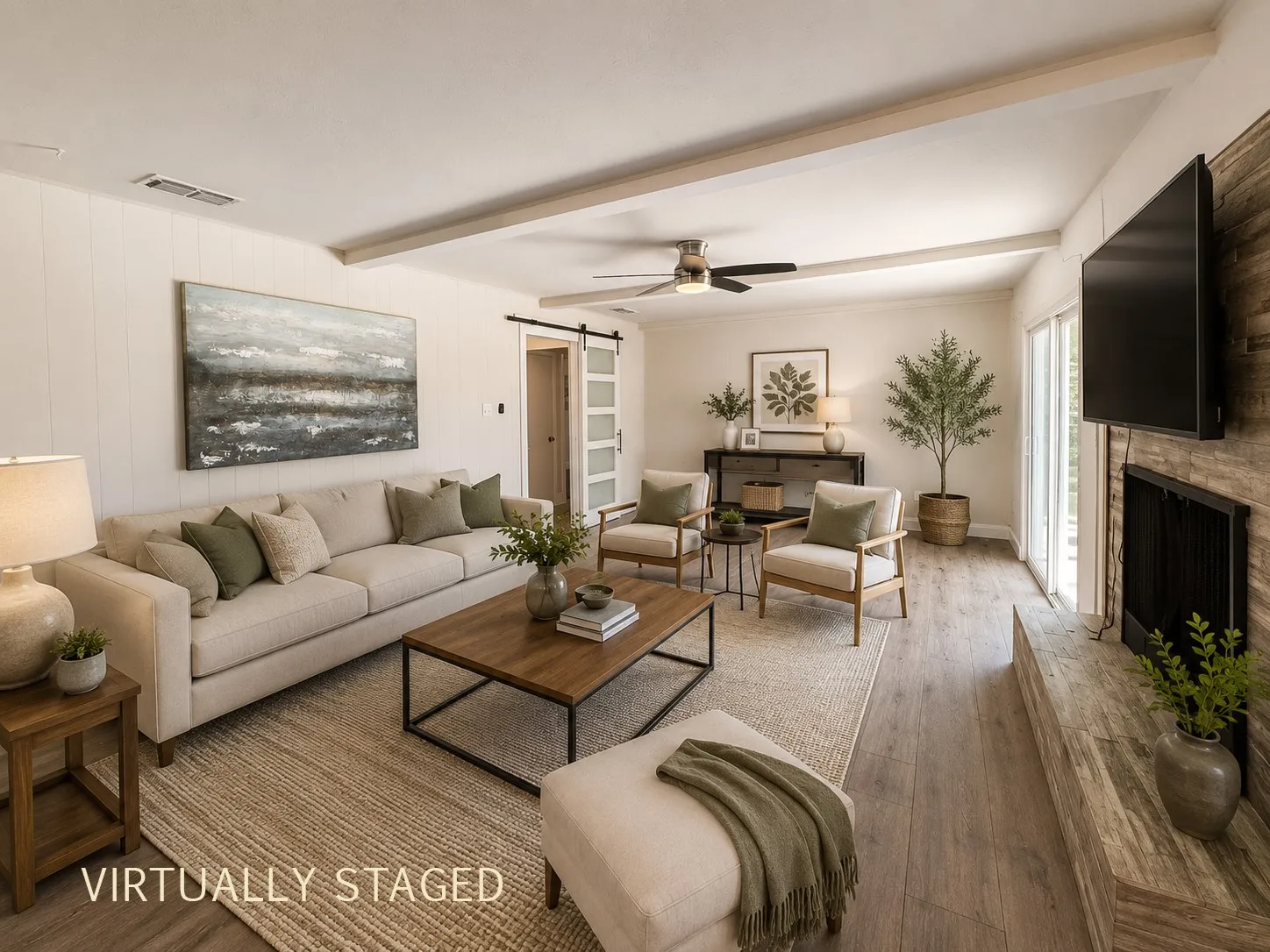 Spacious living area featuring wood-finish flooring, a ceiling fan, and exposed ceiling beams