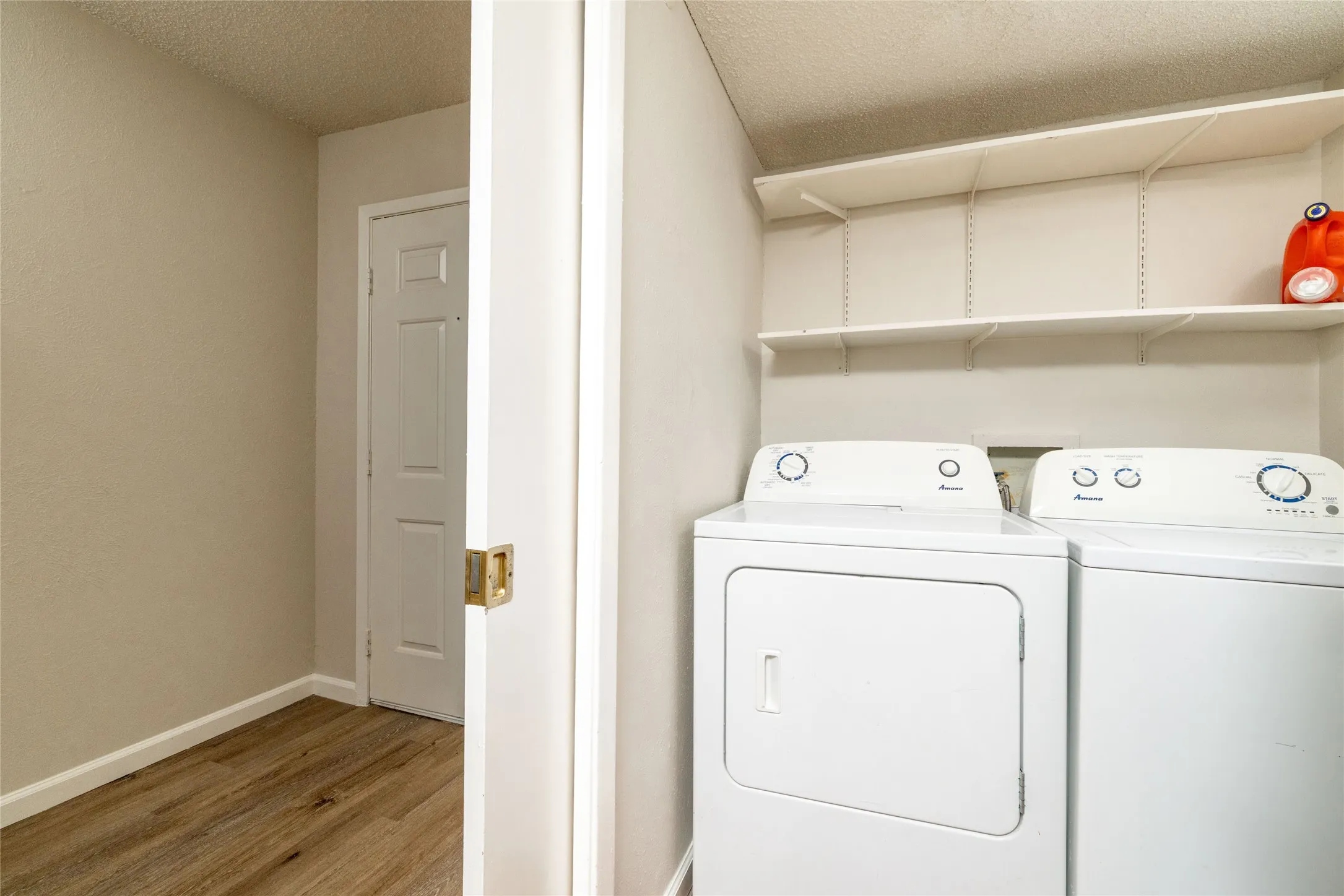 Dedicated laundry area featuring a white top-load washer and dryer set