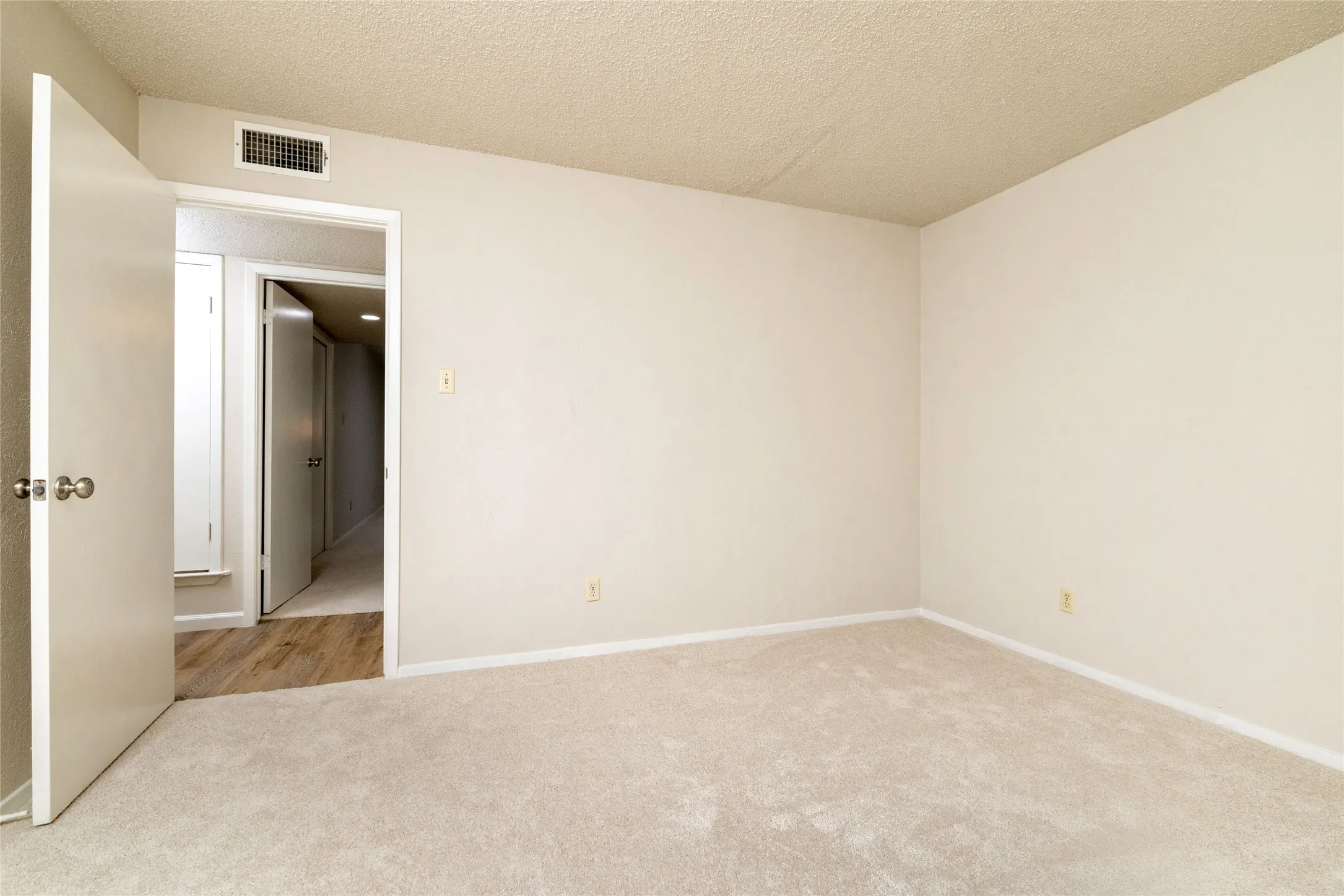Room featuring light-colored carpeting and neutral painted walls