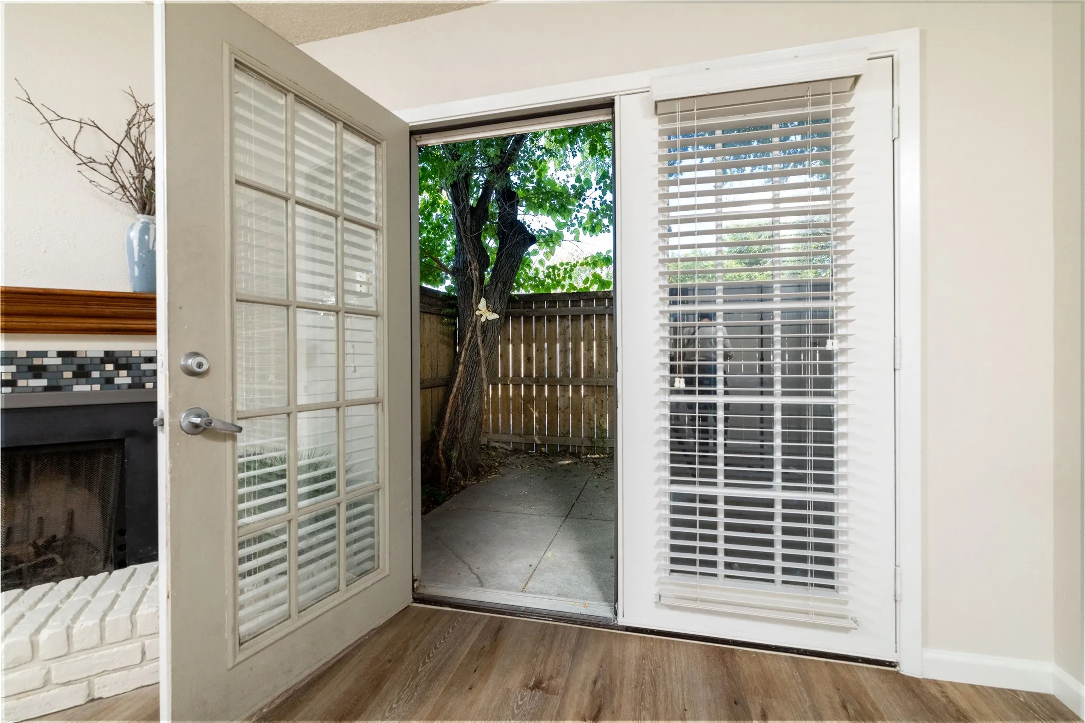 French doors with integrated blinds leading to a private outdoor patio