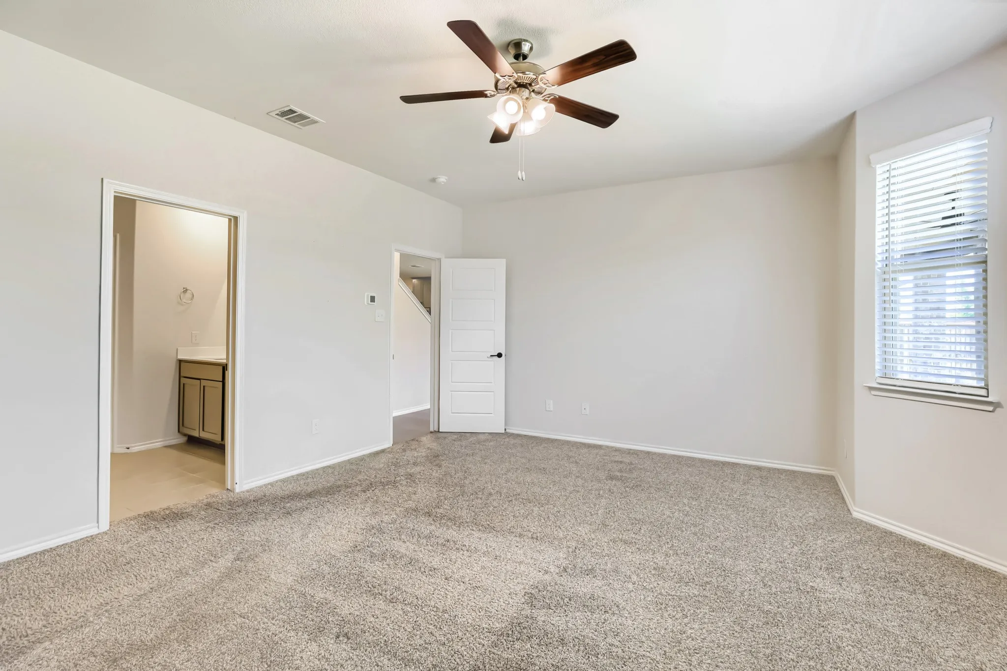 Neutral-toned carpeting throughout