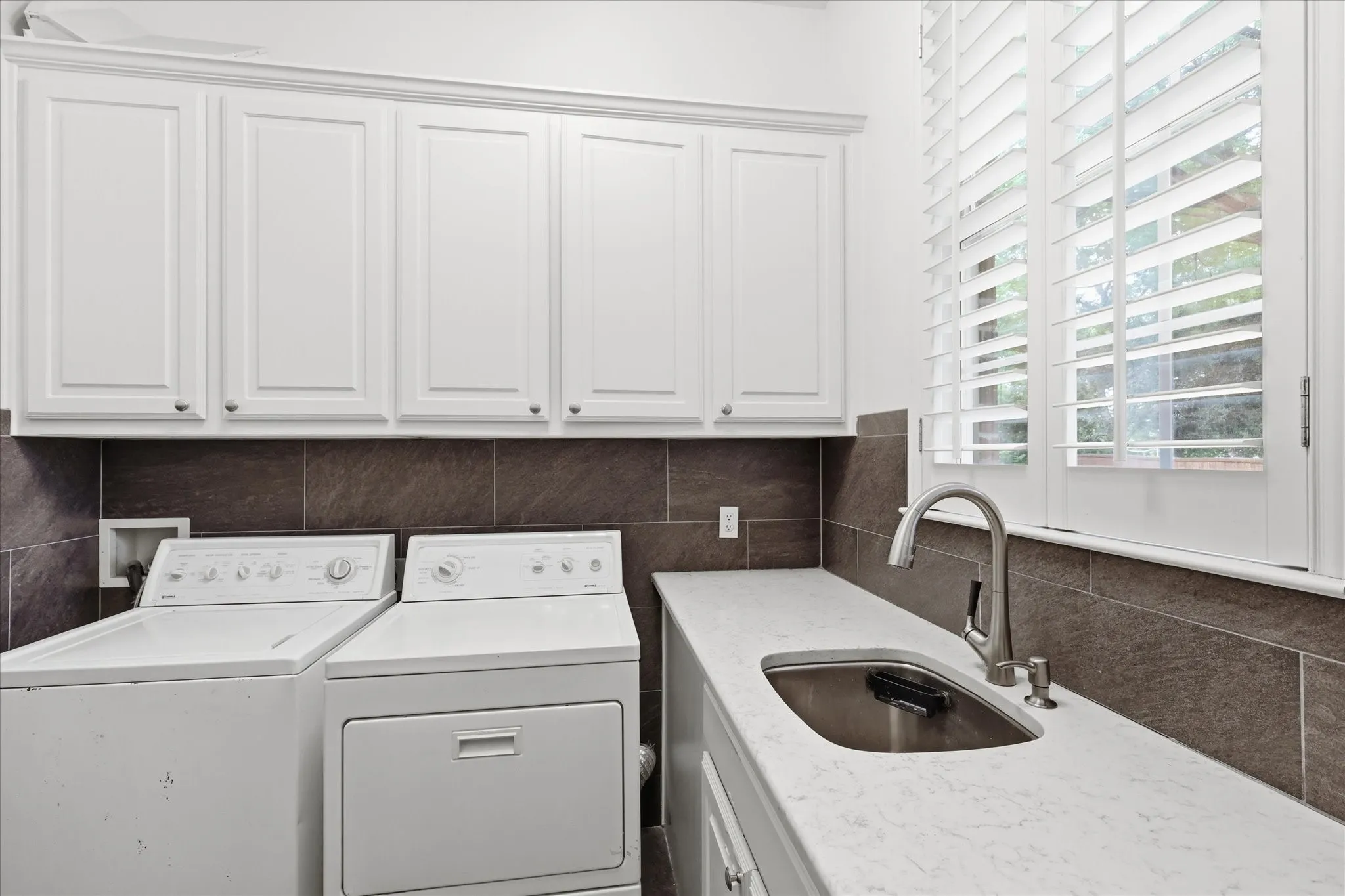 Utility has sink & lots of storage areas.