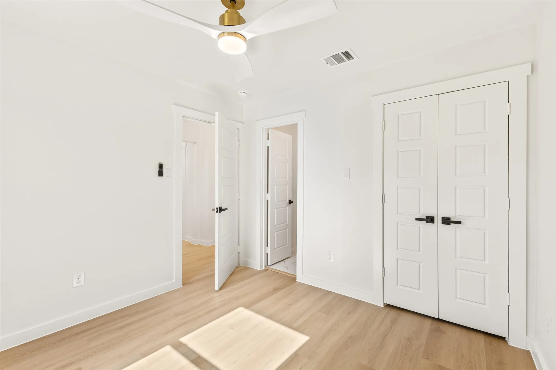 Light wood-finish flooring complements the crisp white walls
