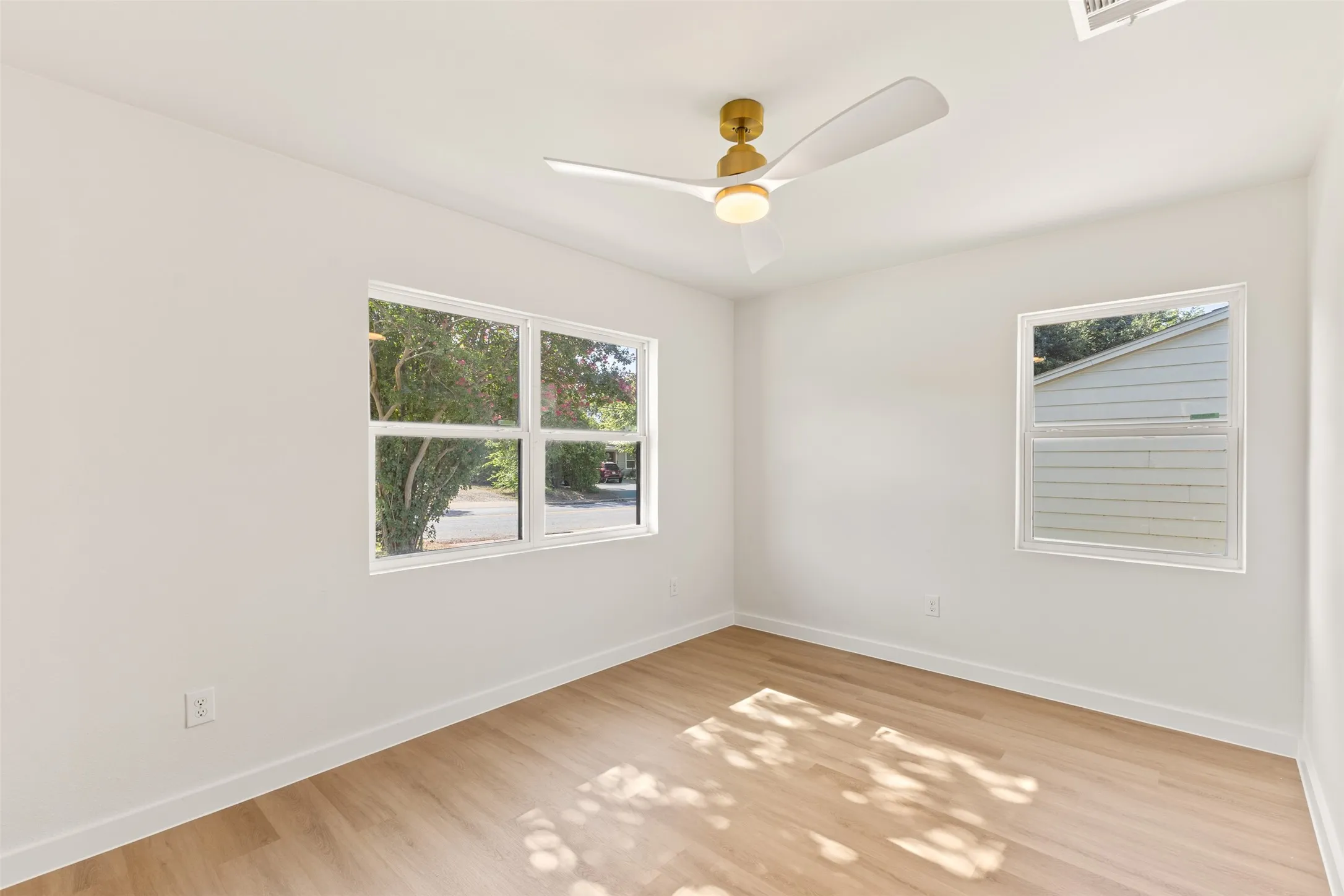 Bright interior space featuring white walls and light wood-finish flooring