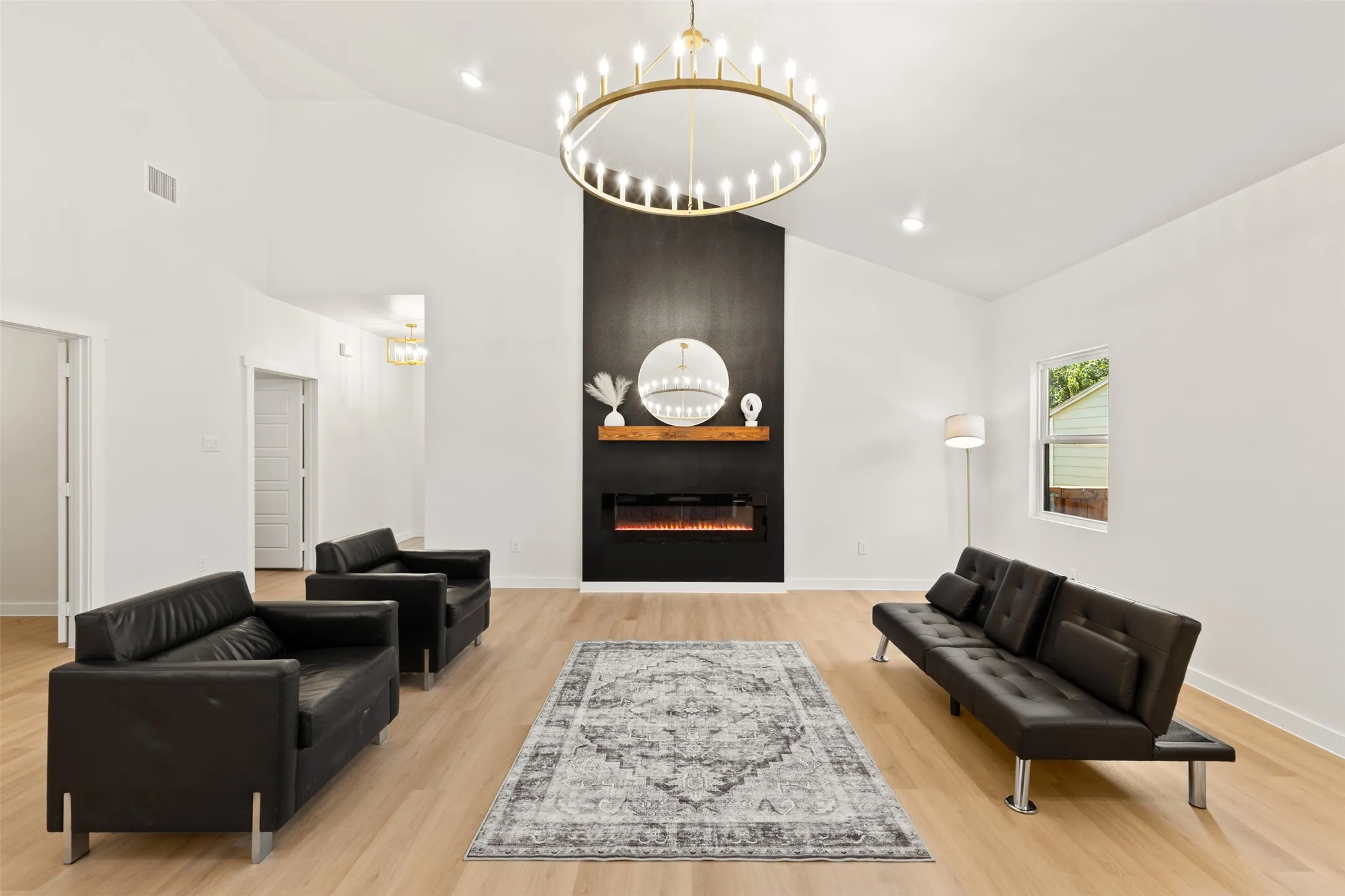 Living area featuring vaulted ceilings and light wood-finish flooring