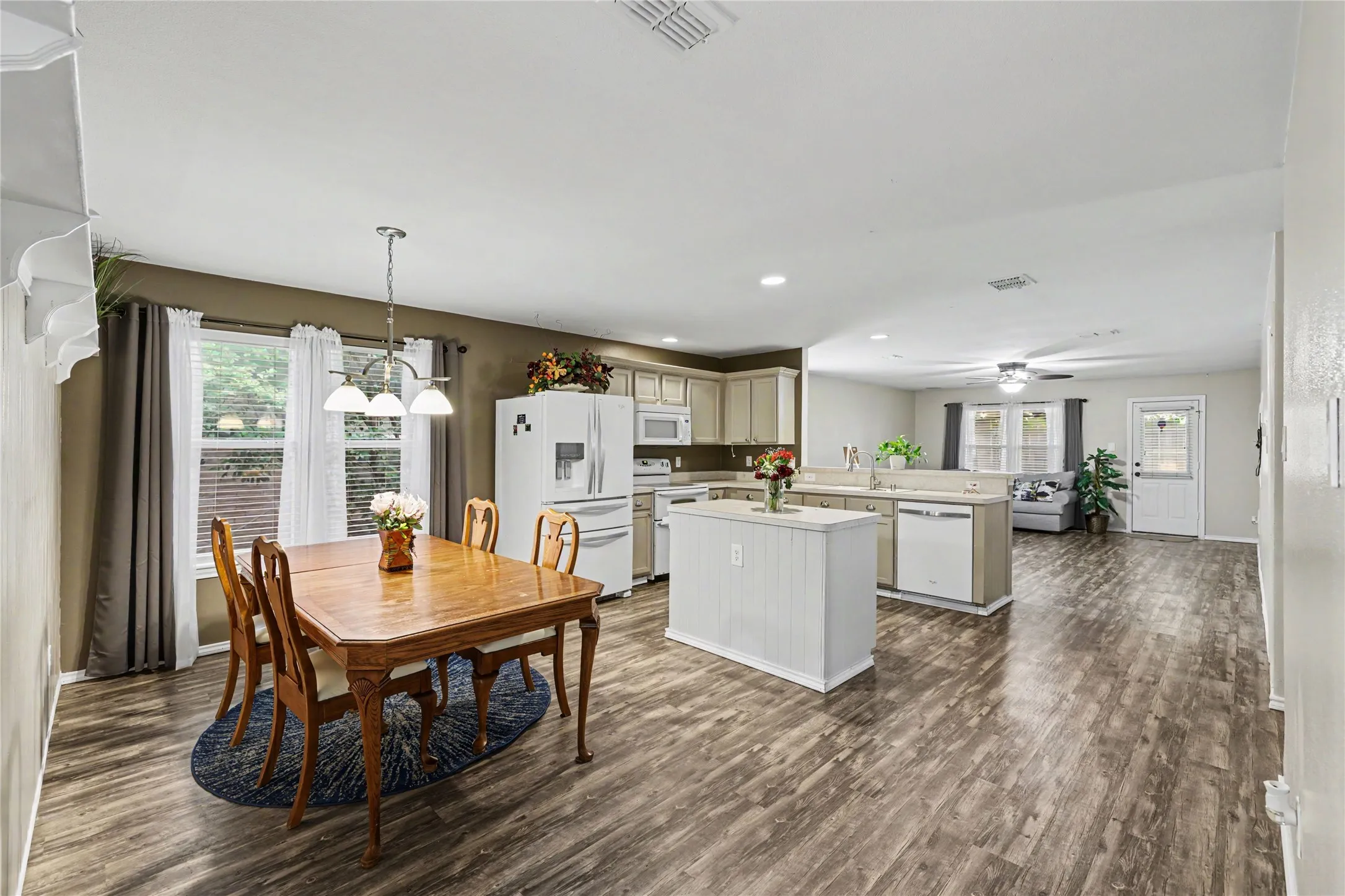 Open-concept living space with wood-finish flooring